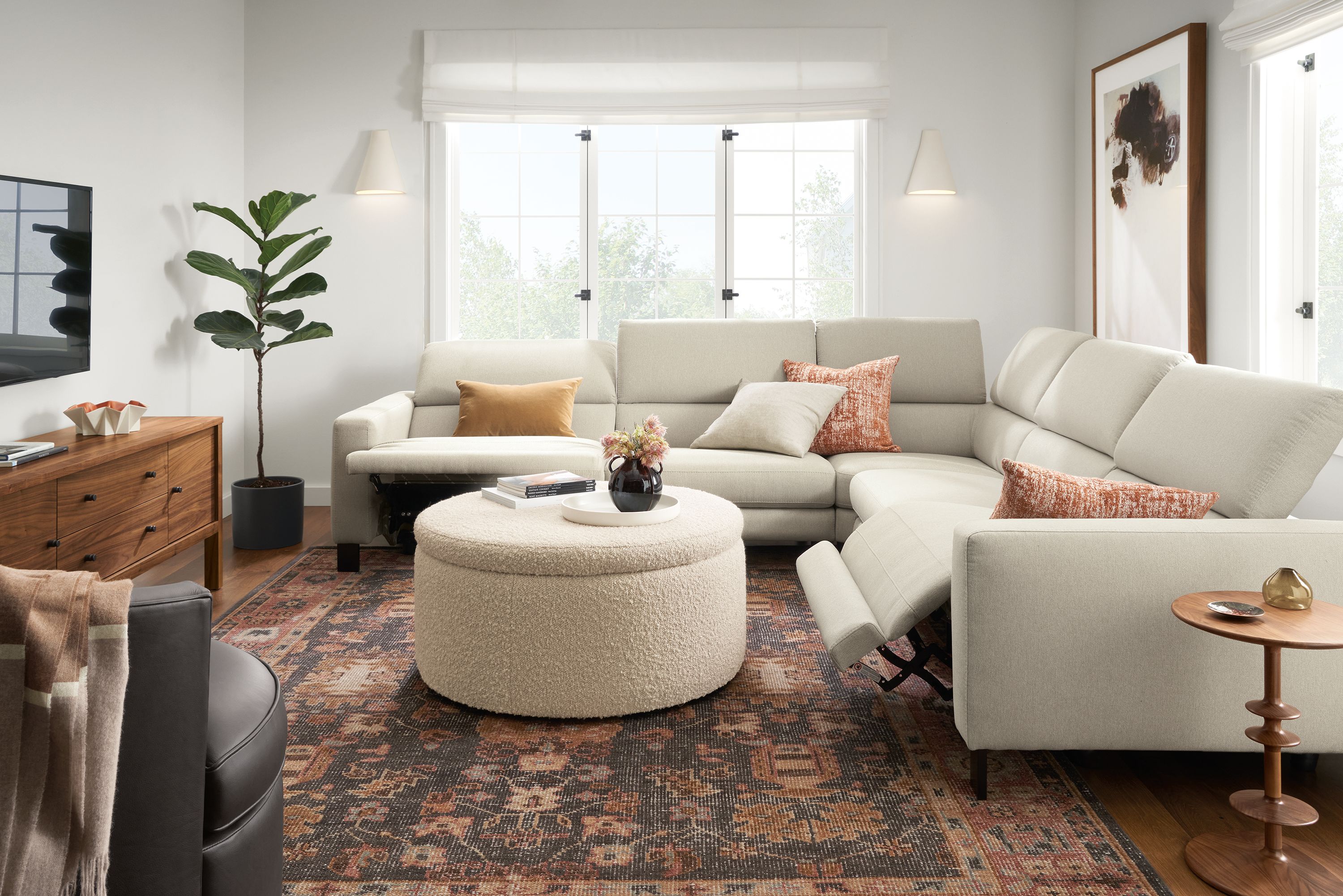 Living room with Elio sectional in sussex cement with two seats shown in reclining position.