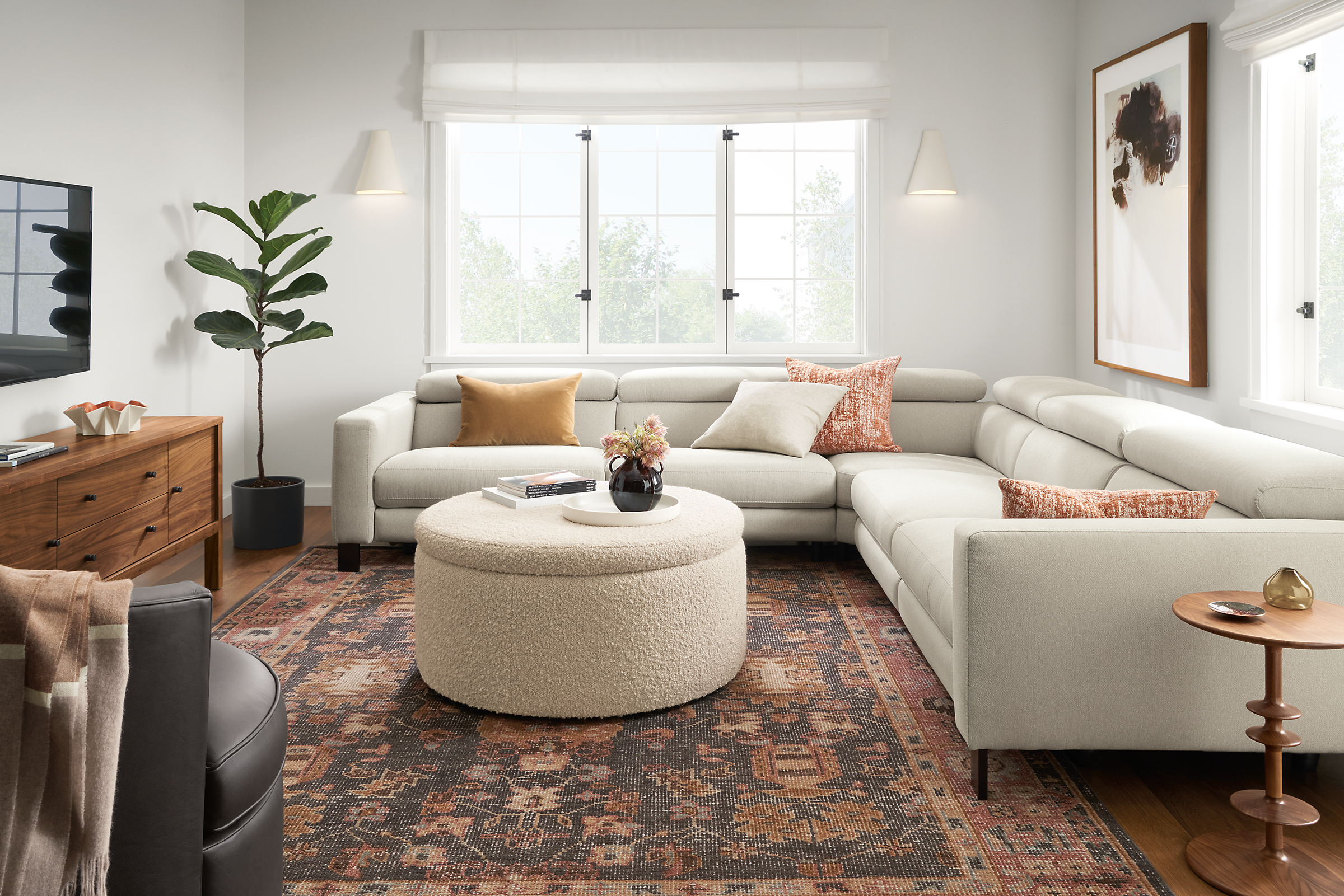 Living room with Elio sectional in sussex fabric, lind storage ottoman, parks end table and Tillia rug.