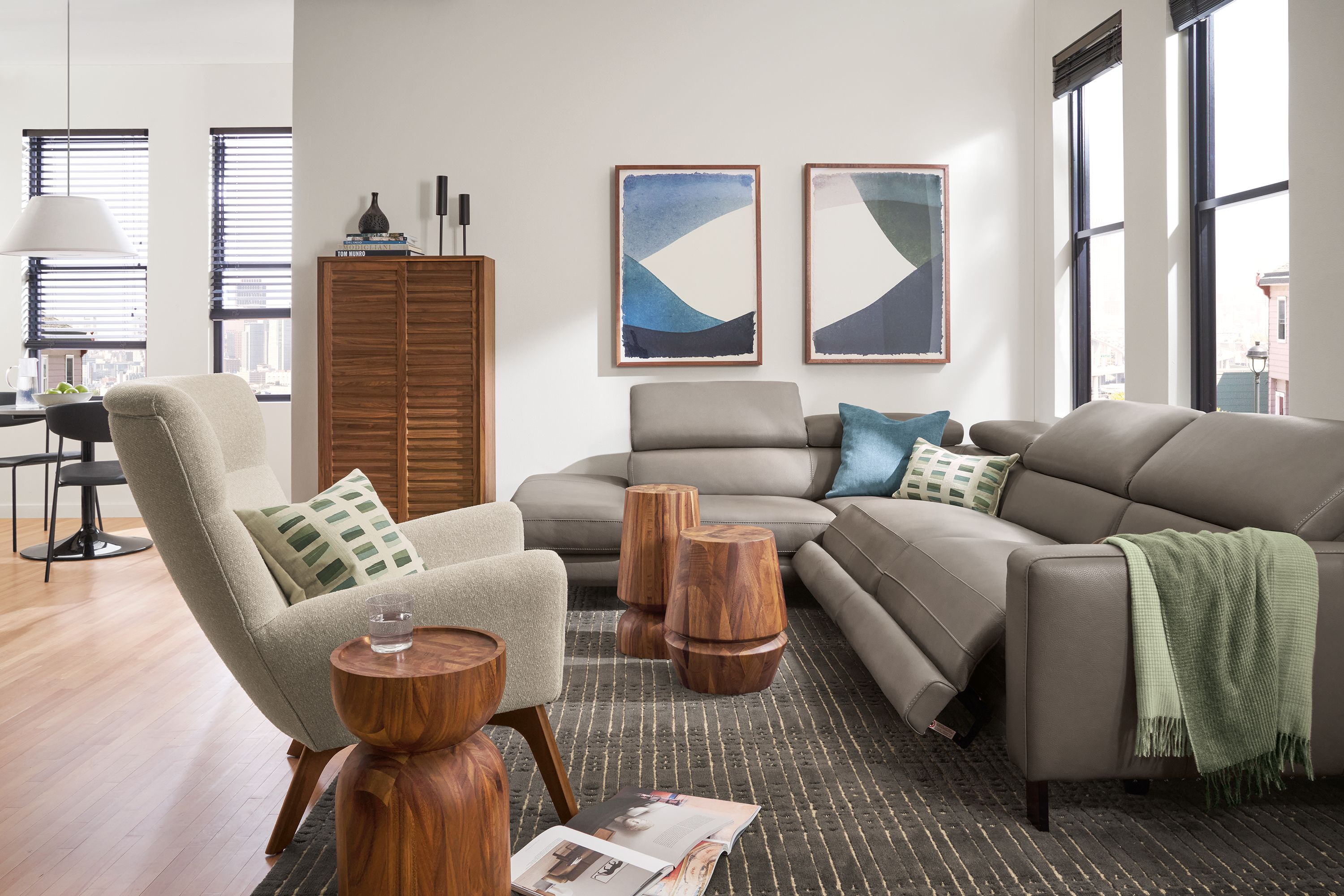 Living room with Elio leather in dario smoke sectional with three headrests and two footrests extended.