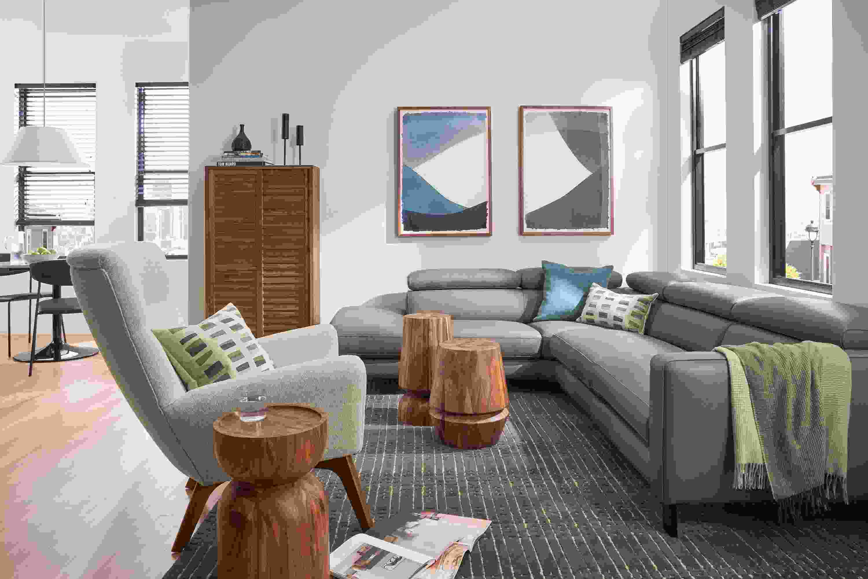 Living room with Elio leather sectional in dario smoke leather, boden chair in conley natural and 3 Nyla tables.