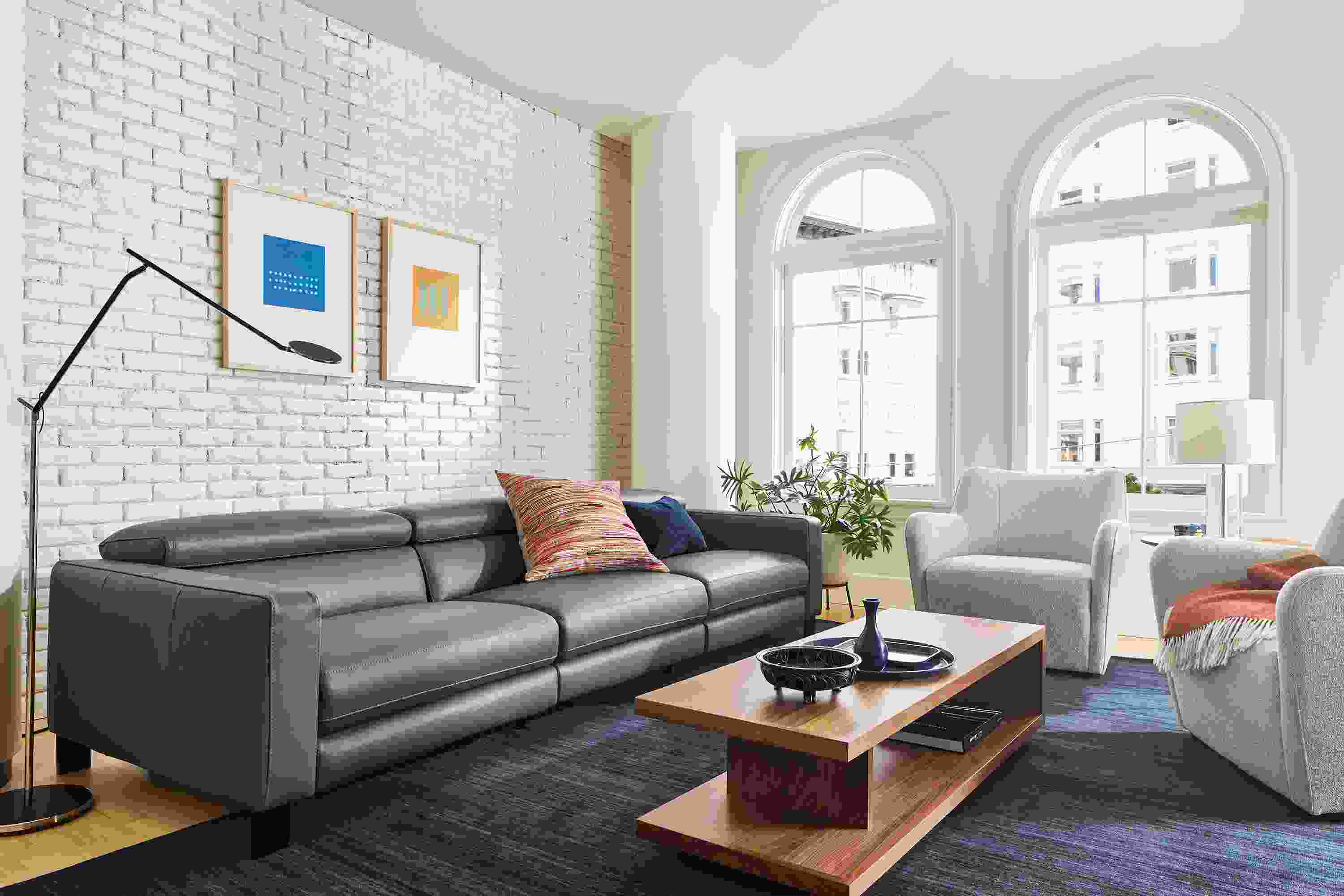 Living room with Elio sectional in dario smoke leather with lily chairs and graham coffee table in walnut.