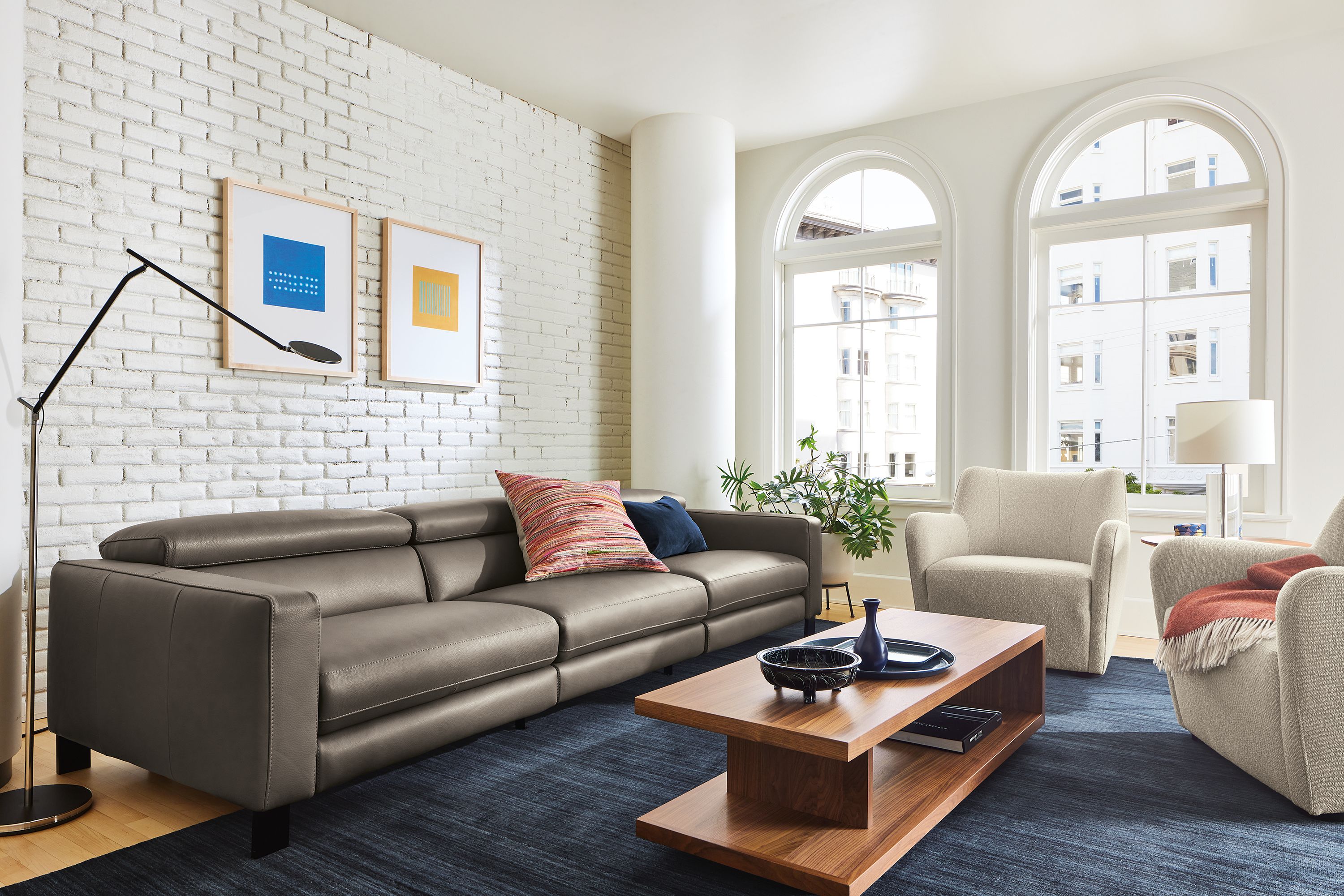 Living room with Elio sectional in dario smoke leather with lily chairs and graham coffee table.