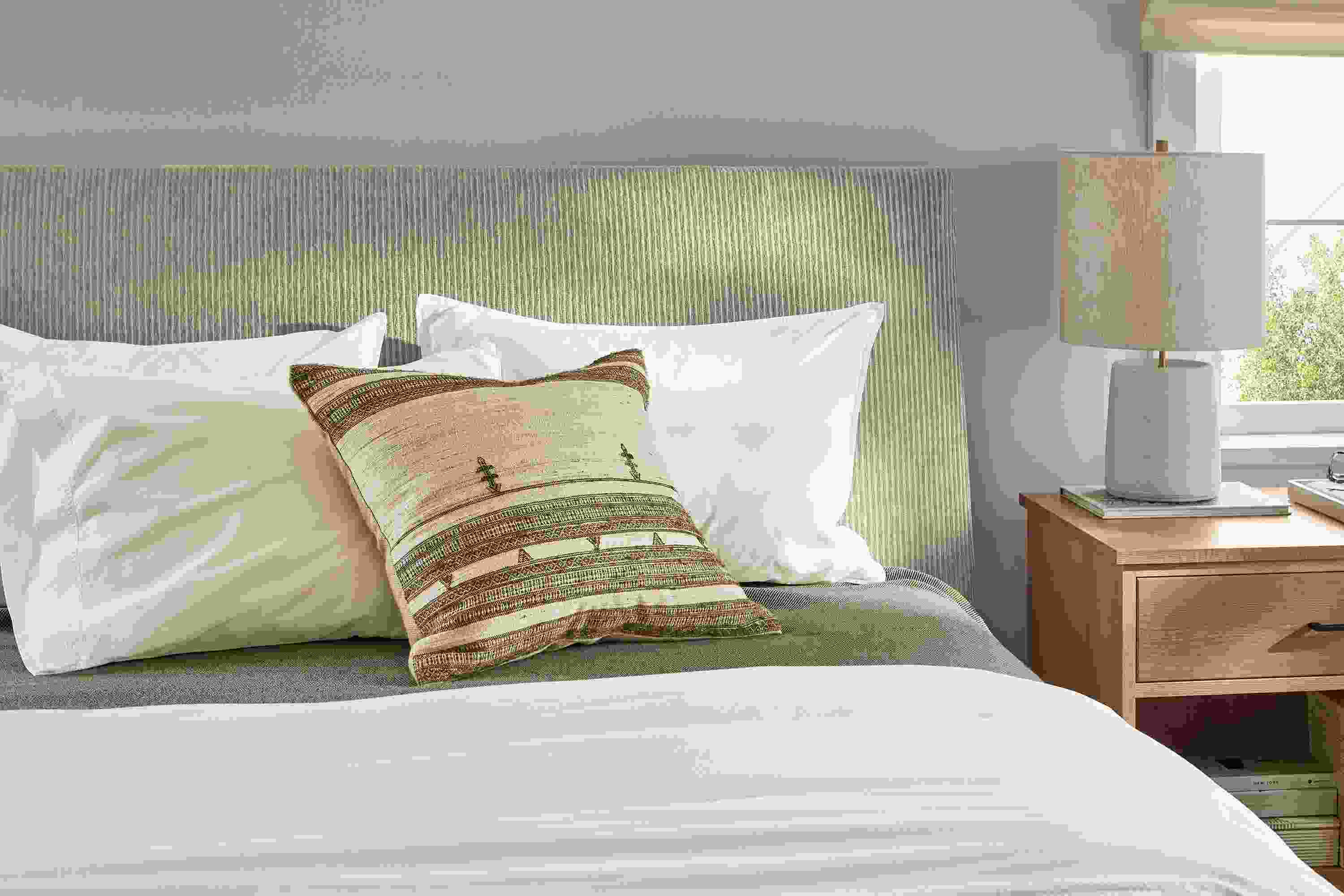 Bedrooom with detail of Ella Queen bed in Brava camel with Linear nightstand in Rye on Red Oak.