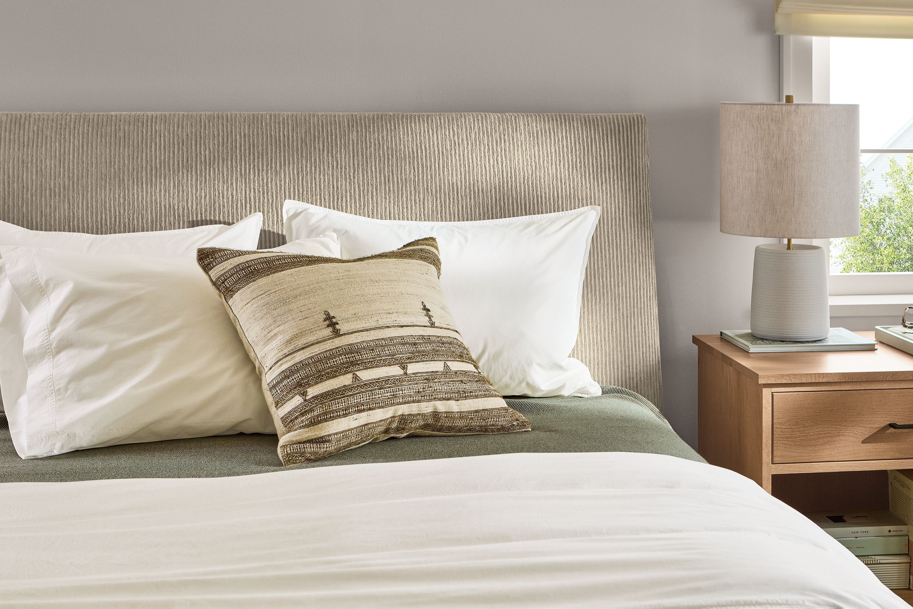 Queen bed in Brava camel fabric with graphite legs