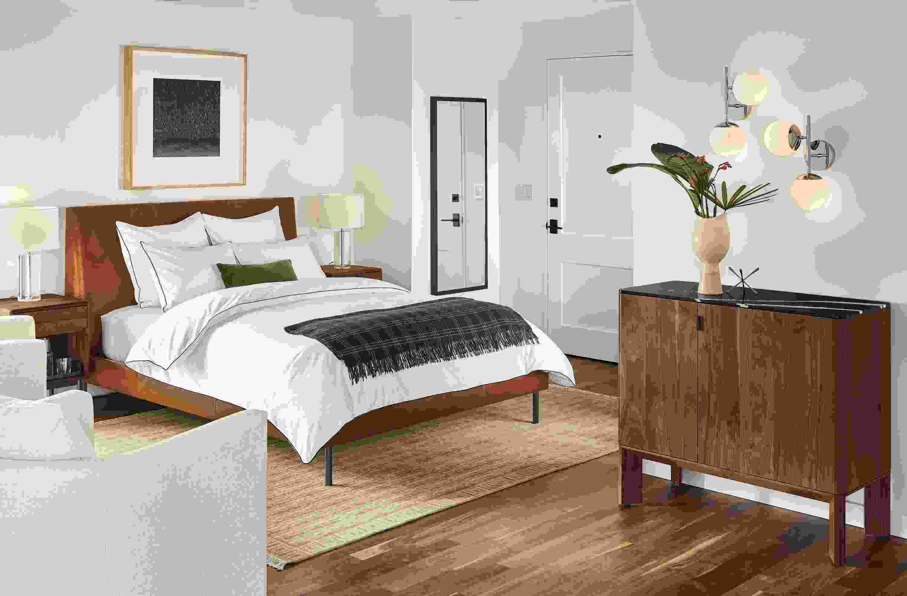 Detail of Ella queen bed in Vento Cognac leather in bedroom with Pren bar cabinet.
