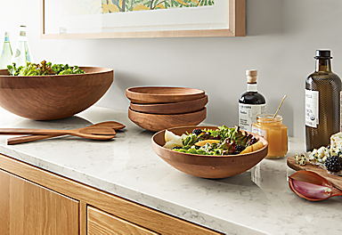 Kitchen counter with Elliott wood salad serving bowl set and Moore 12-inch wooden spoon and fork salad serving set in cherry.