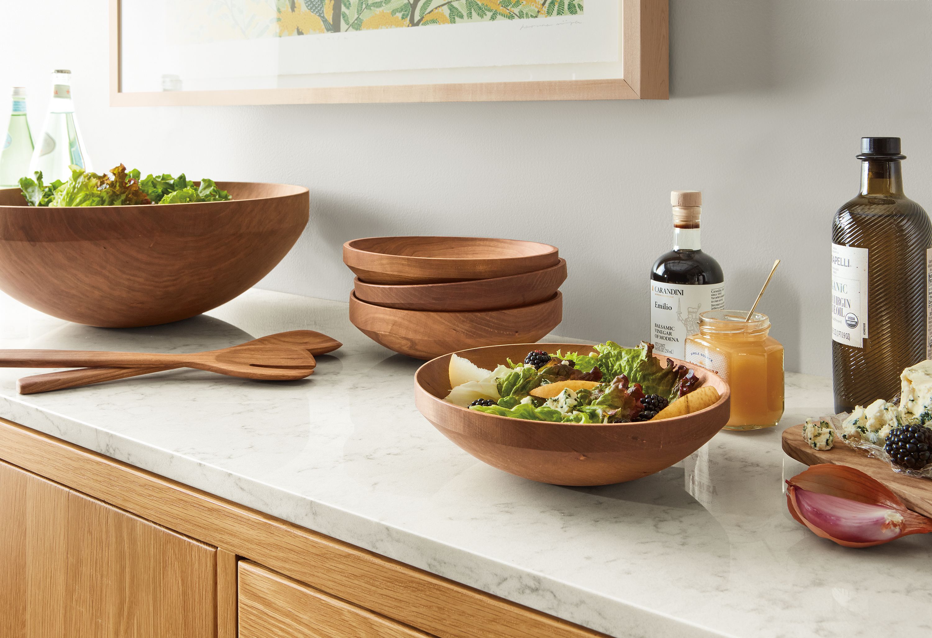 Kitchen counter with Elliott wood salad serving bowl set and Moore 12-inch wooden spoon and fork salad serving set in cherry.