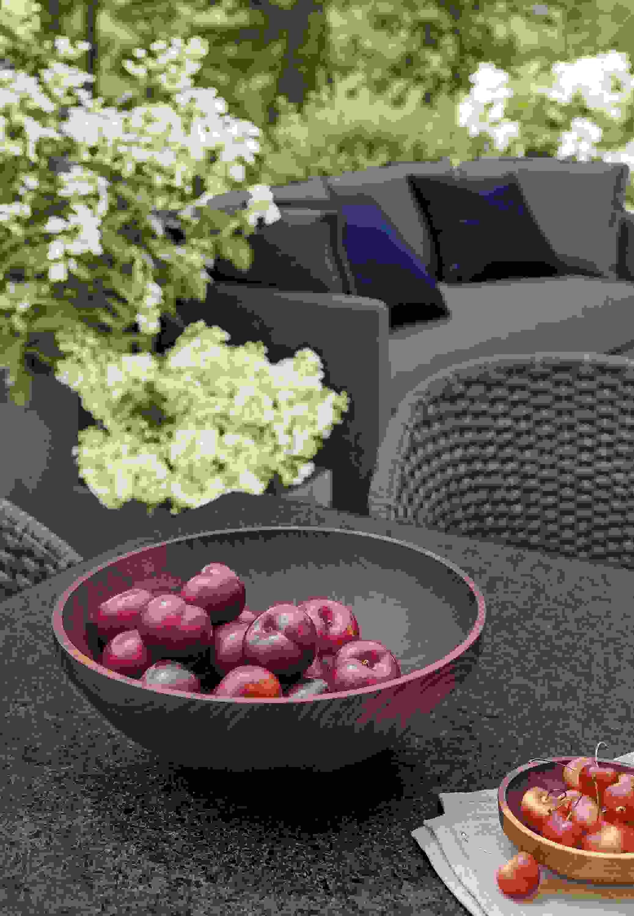 Detail of Elliott wood bowl in walnut on outdoor table.