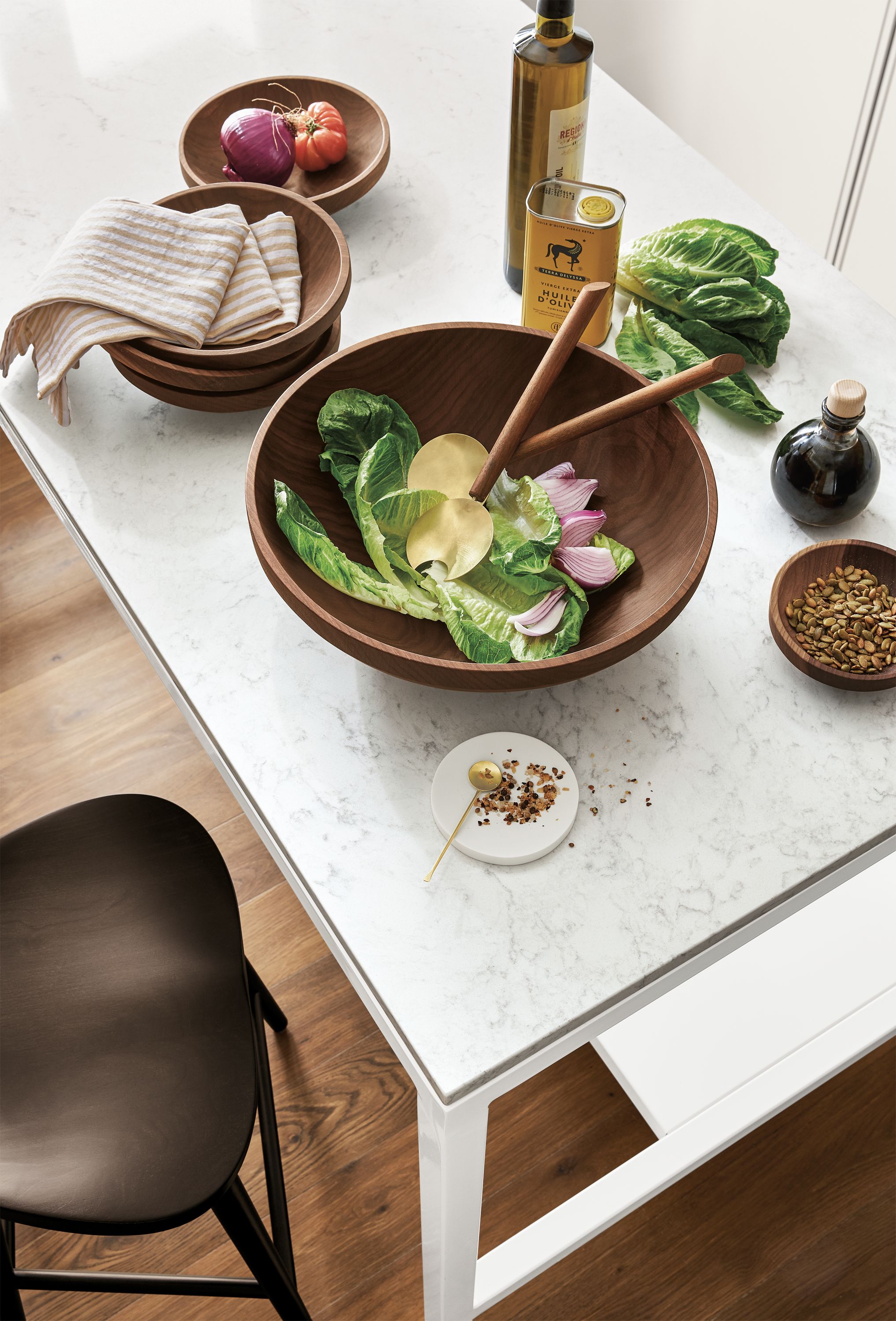 Detail of Calder bowls in walnut on kitchen counter for serving and salad tossing.