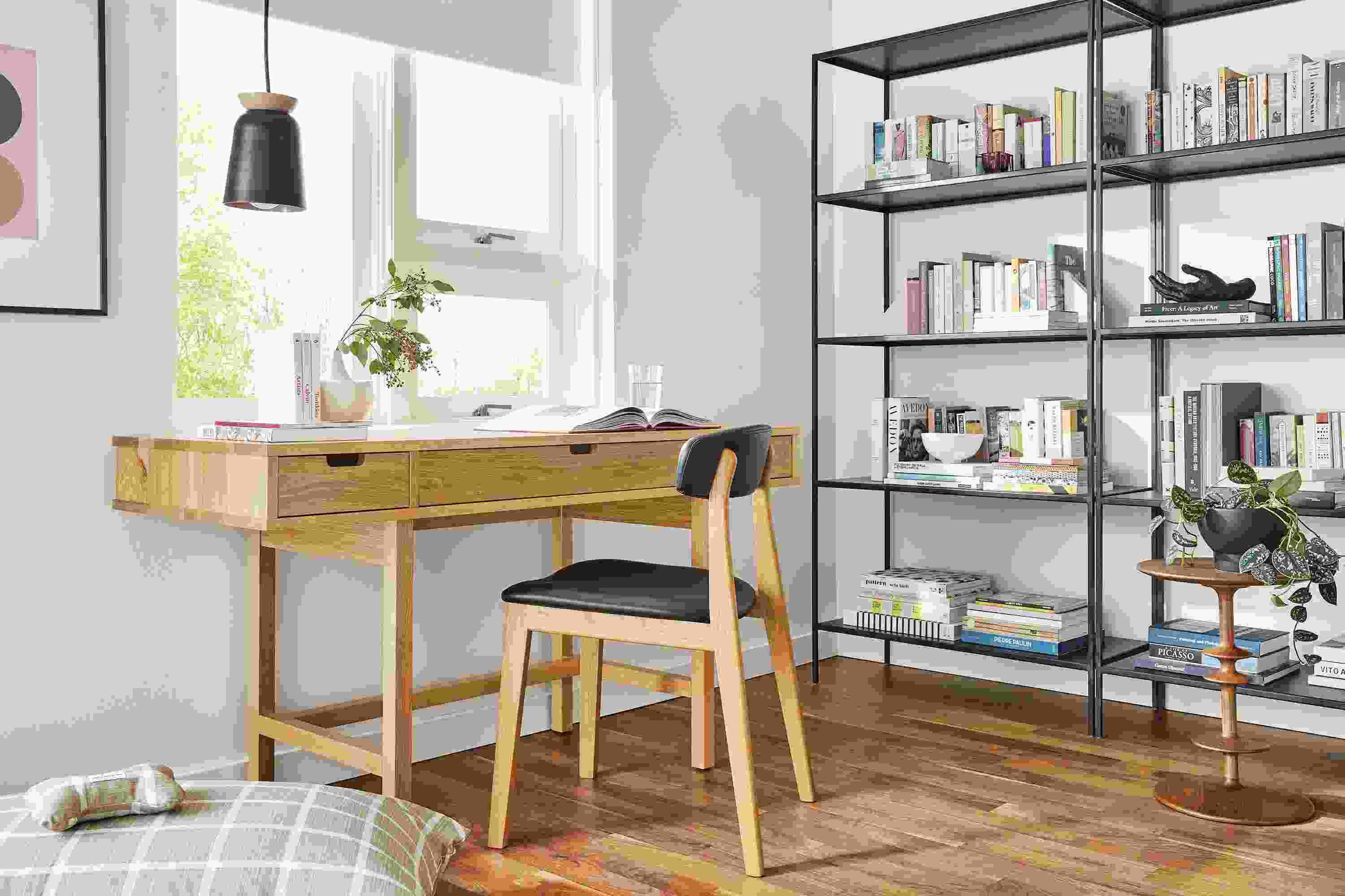 Living space with Ellis Desk in White Oak, Errol Chair and Slim bookcases in Natural Steel.