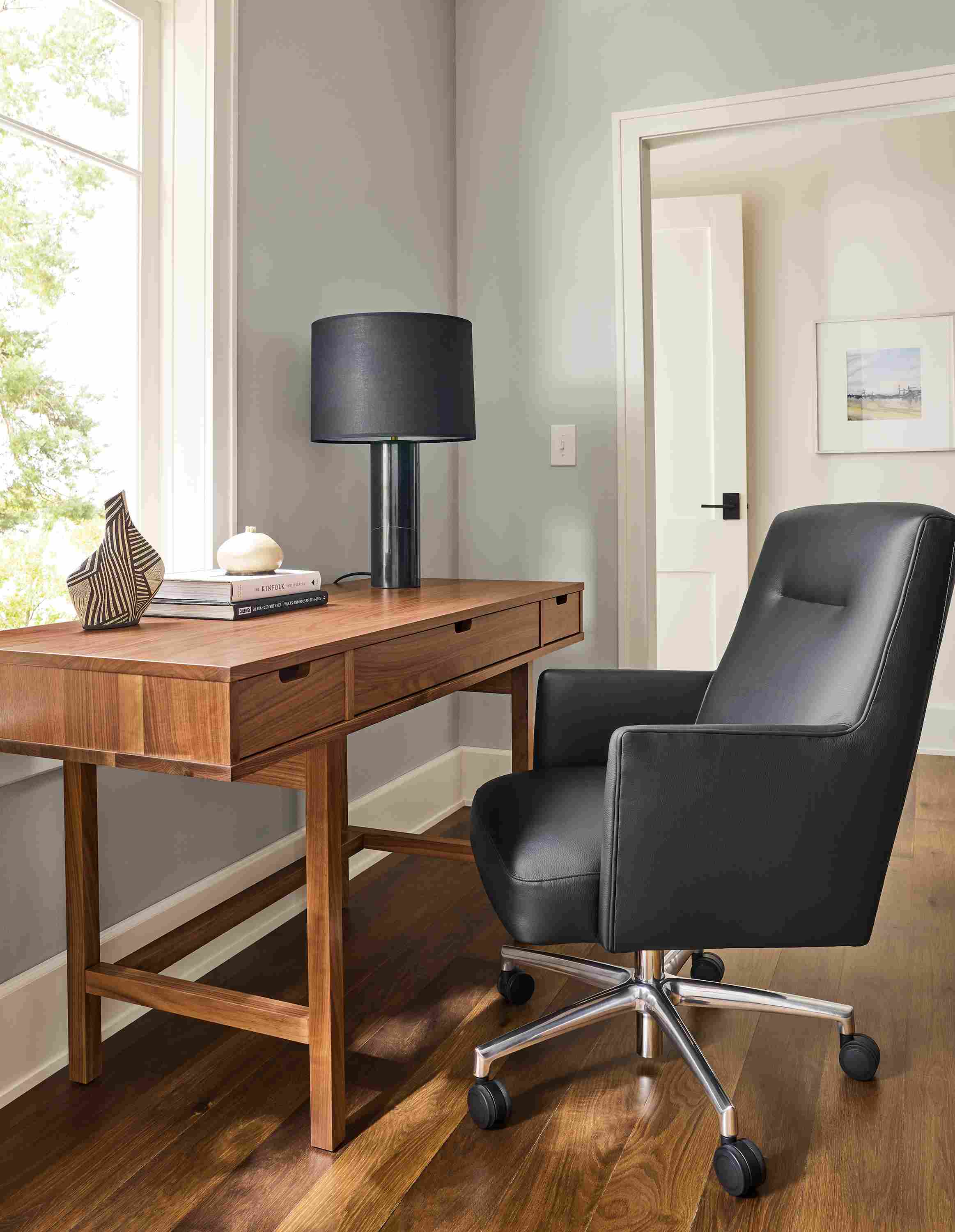 Home office with ellis 56-wide desk in walnut and Jude office chair in Pesaro black leather and polished aluminum.