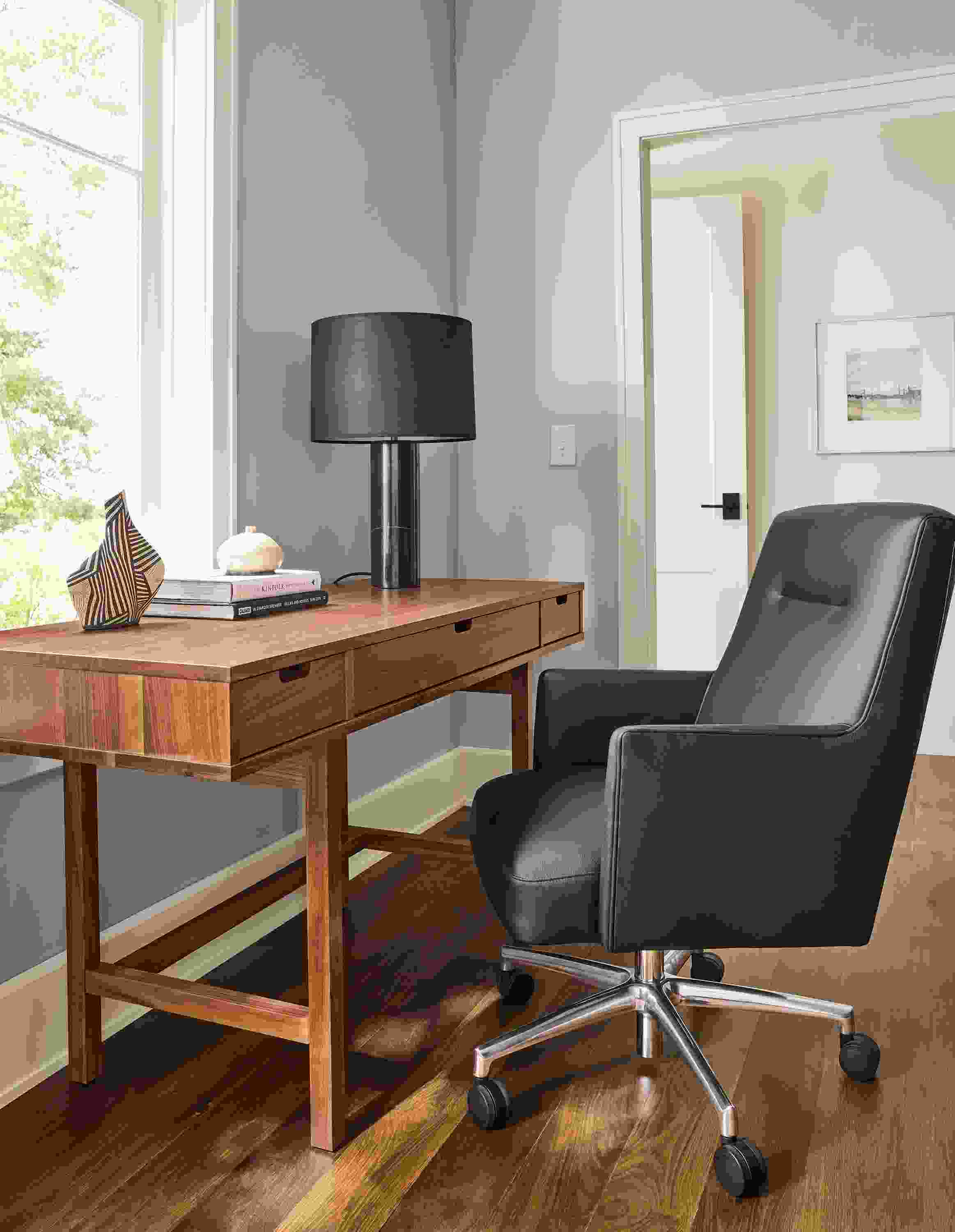 Home office with ellis 56-wide desk in walnut and Jude office chair in Pesaro black leather and polished aluminum.