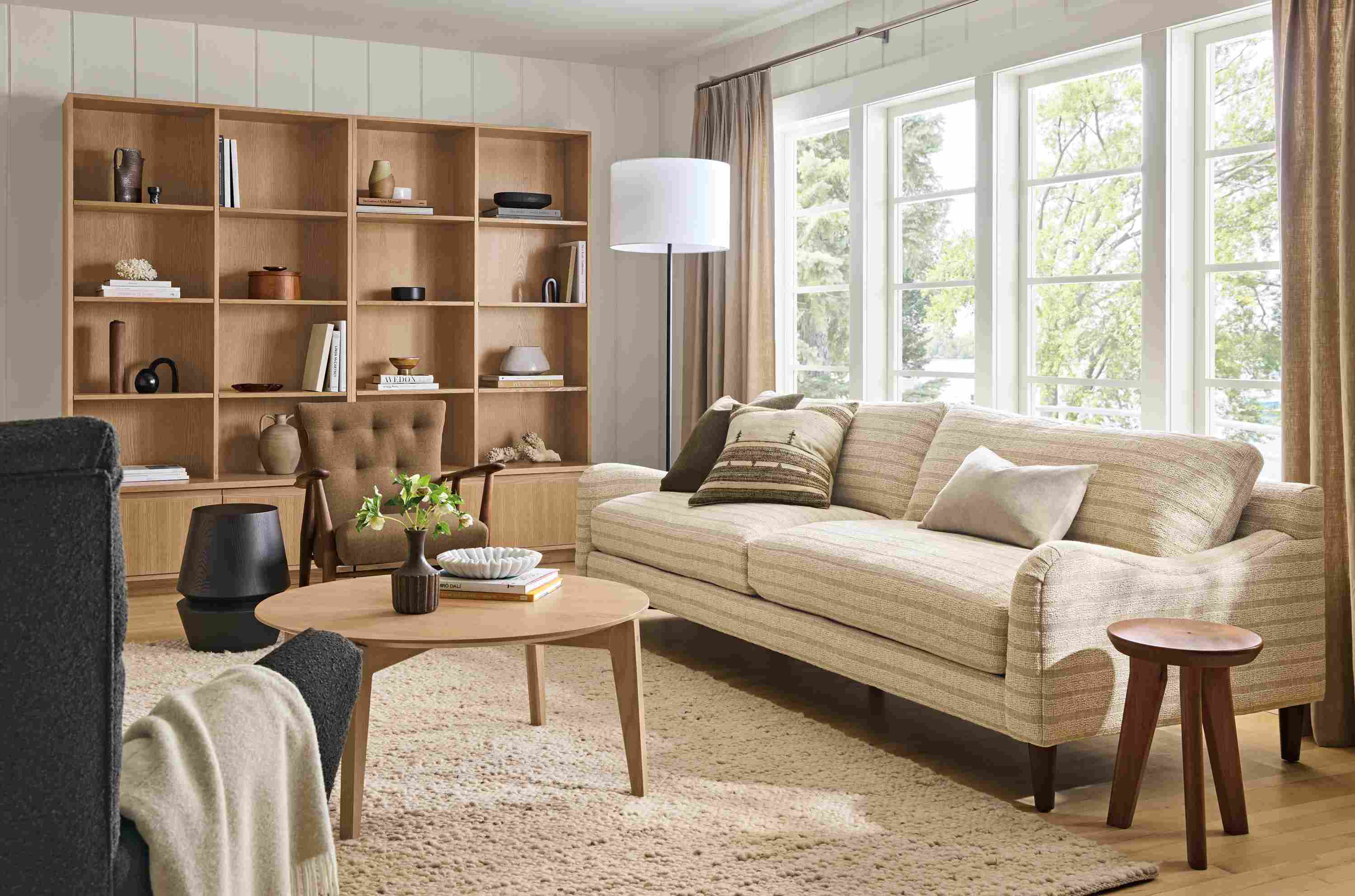 Living room with Eloise sofa in Auckland Natural, Jonas lounge chair in Myers cognac and Cobble rug in Ecru.