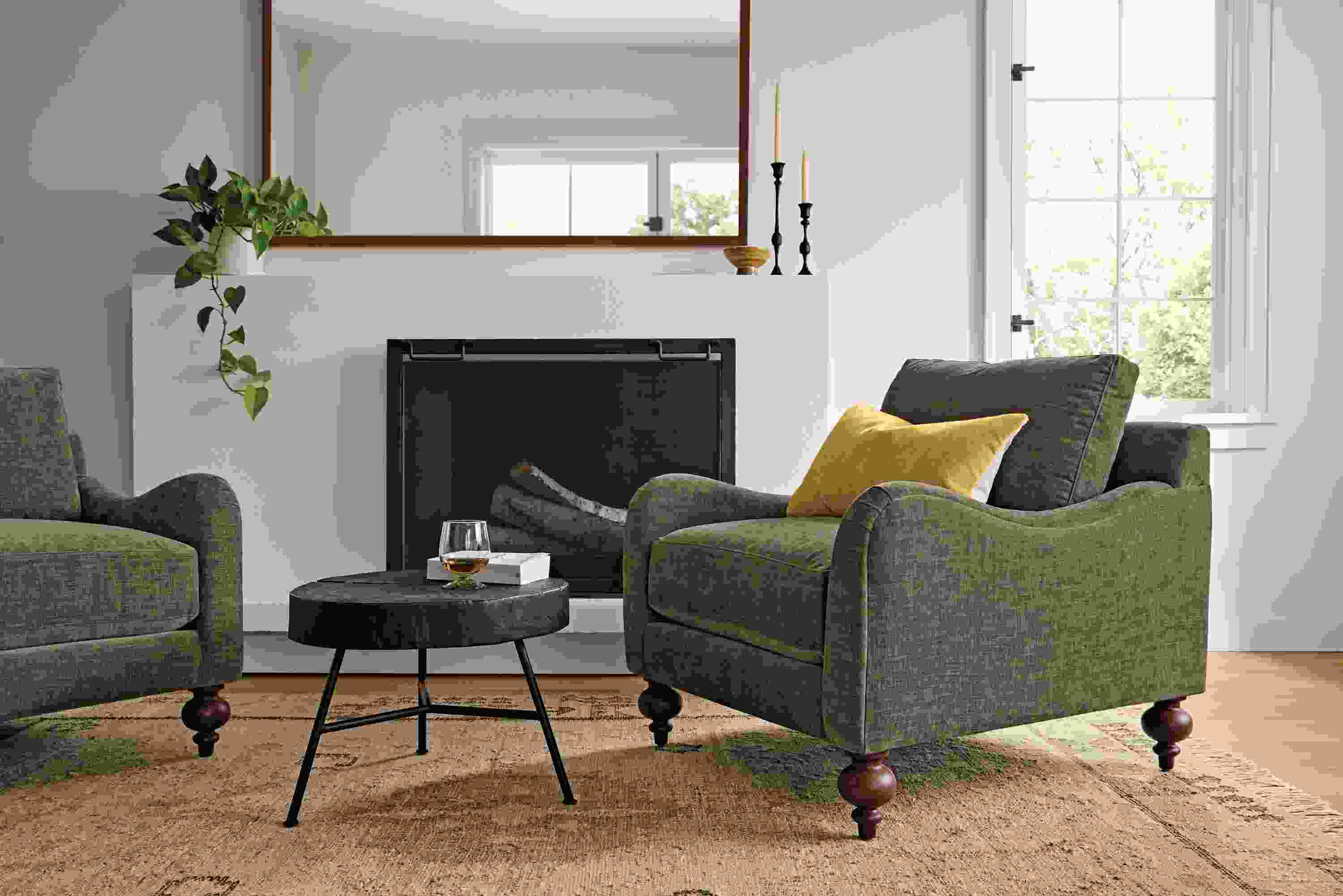 Living room in Eloise chair in Mori Olive, Prospect coffee table in charred reclaimed ash and Villa rug in sand.
