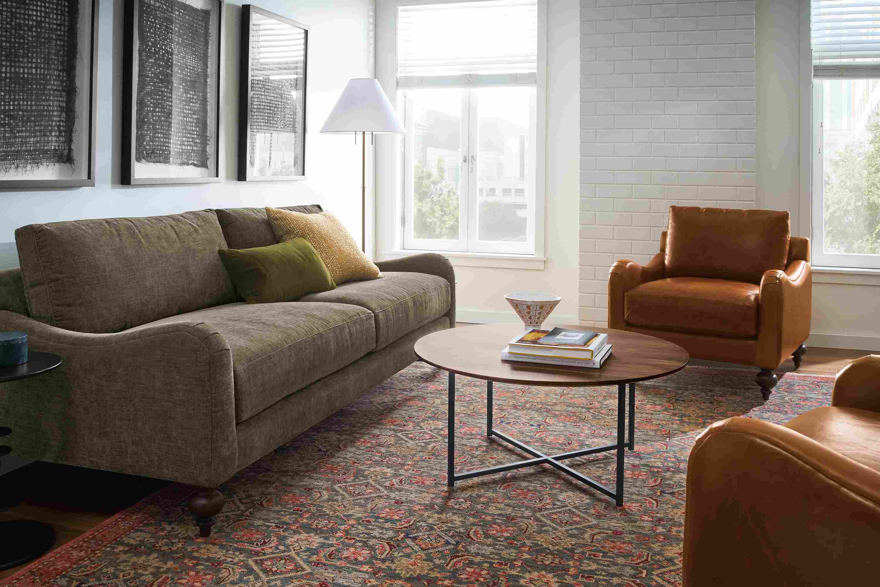 Living room with Eloise 87-wide sofa in Mori Olive and 2 Eloise chairs in Vento Cognac leather.