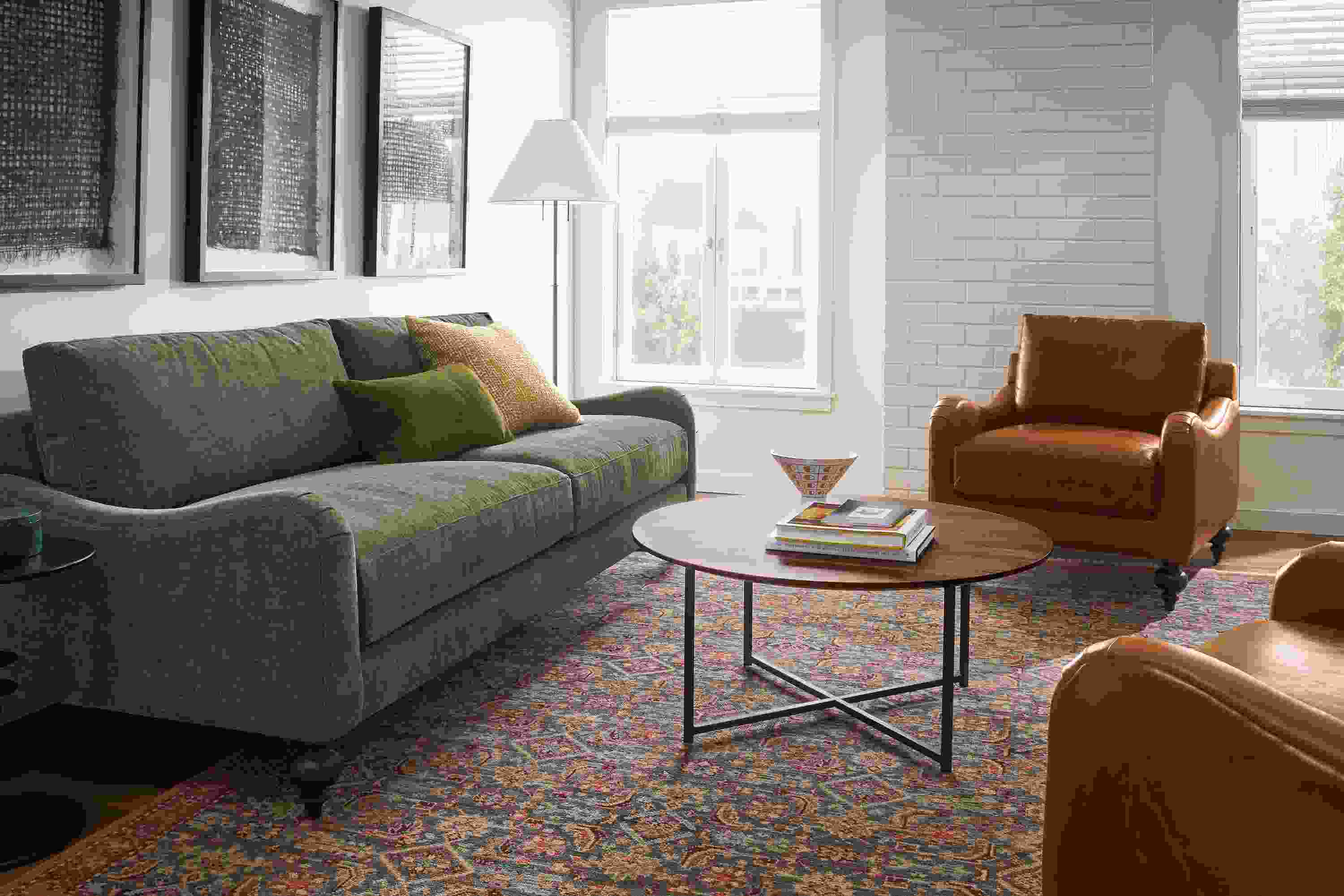 Living room with Eloise 87-wide sofa in Mori Olive and 2 Eloise chairs in Vento Cognac leather.