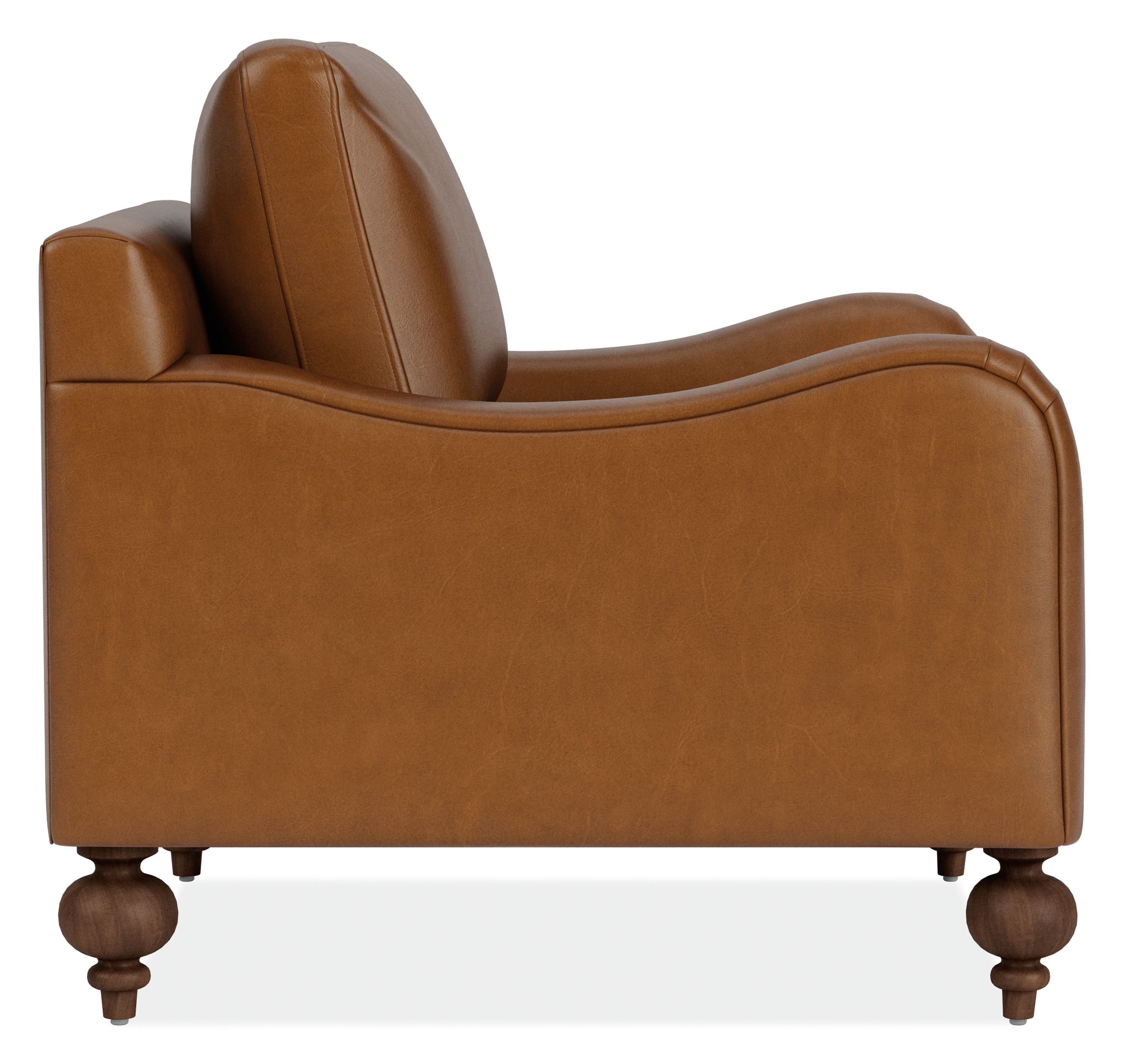 Side view of Eloise Chair in Vento Cognac Leather with Mocha-stained  turned legs.
