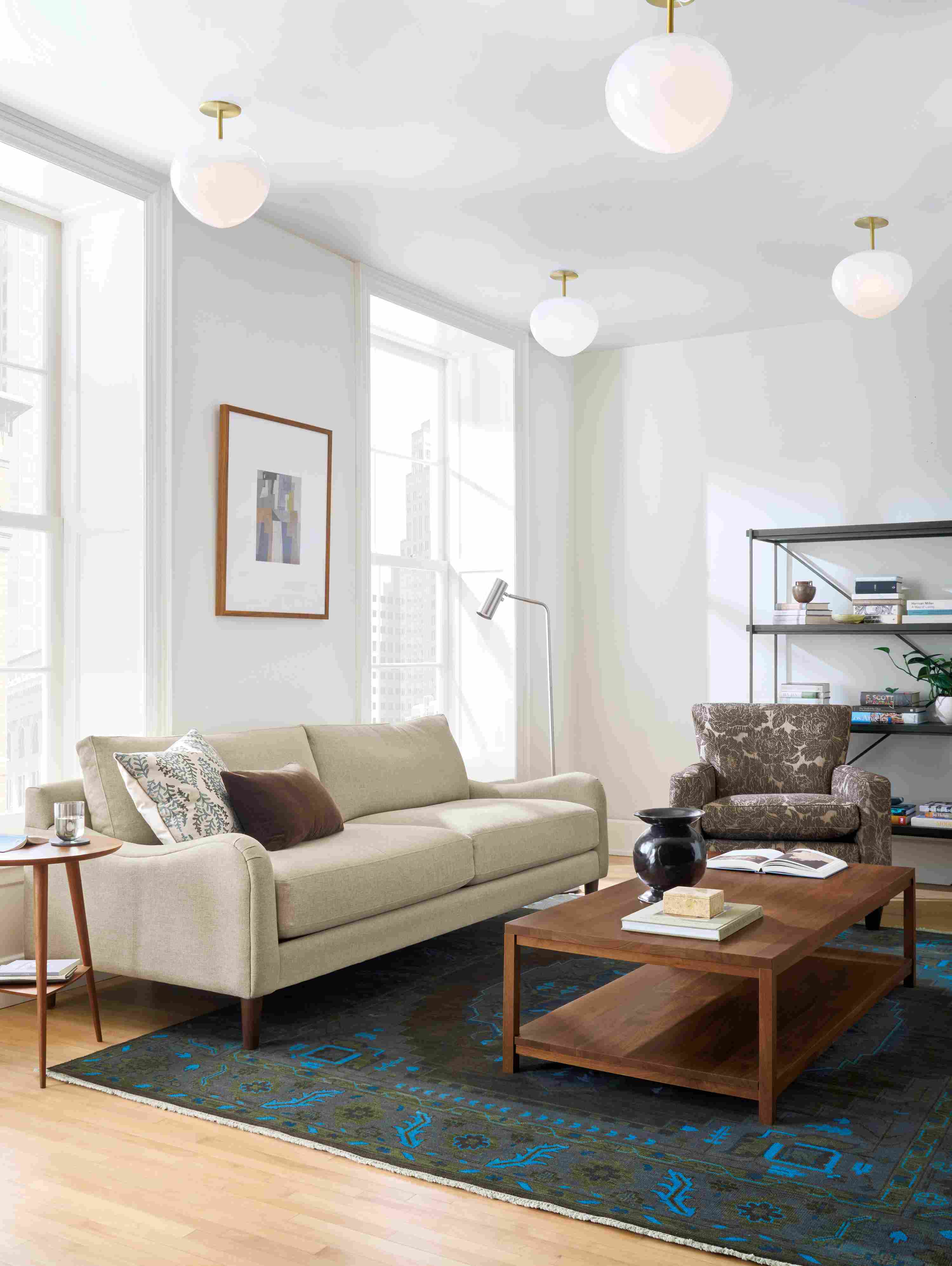Living room with Eloise sofa in Sumner Flax, Savoy chair in Caldwell Flax and Clark coffee table in walnut.