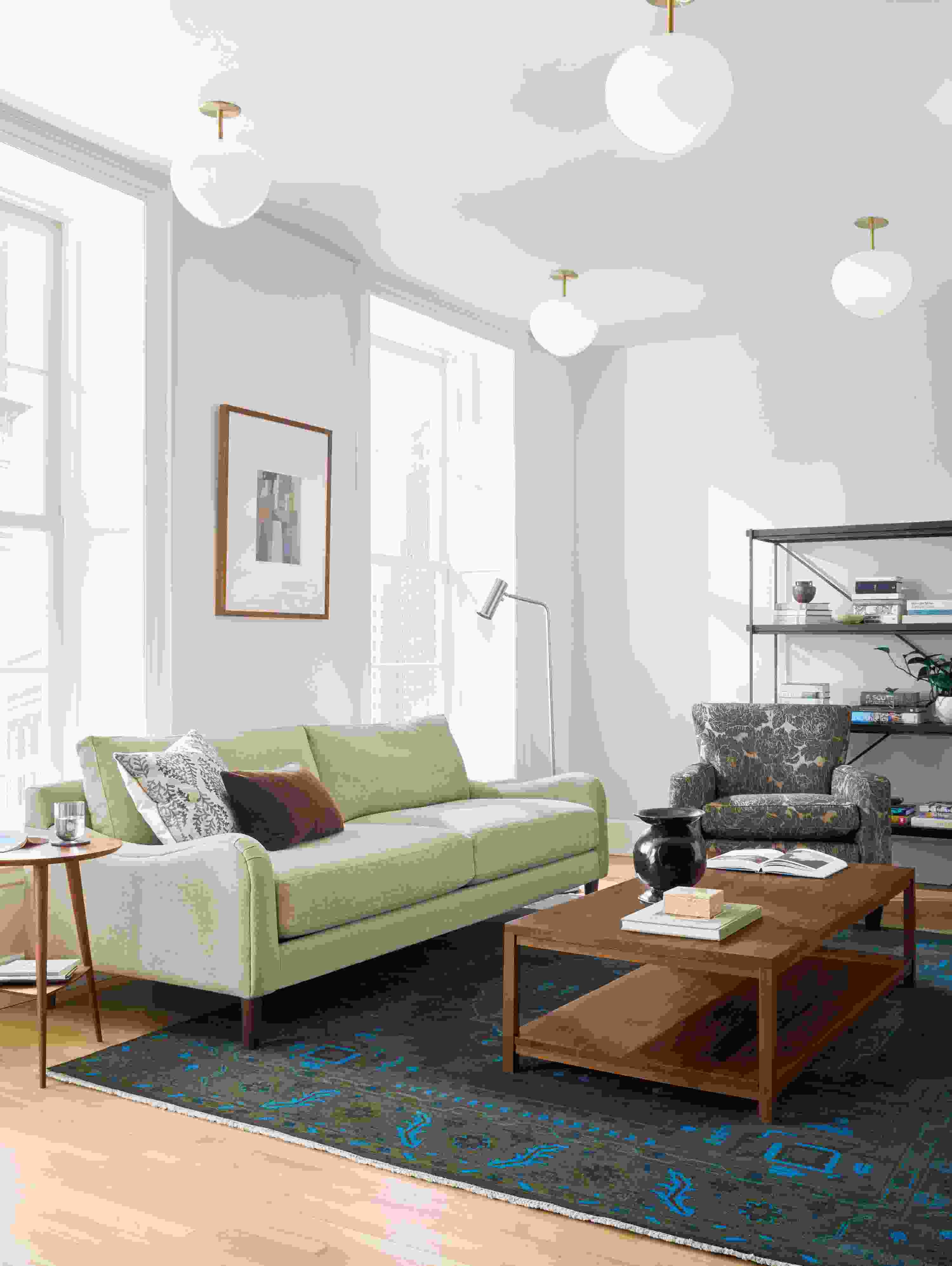 Living room with Eloise sofa in Sumner Flax, Savoy chair in Caldwell Flax and Clark coffee table in walnut.