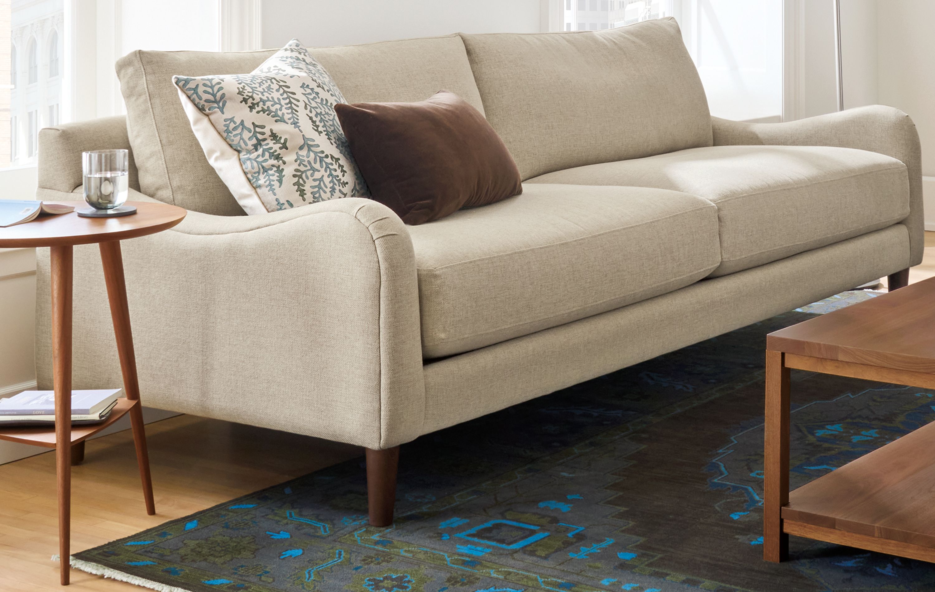 Living room with Eloise sofa in Sumner Flax, Savoy chair in Caldwell Flax and Clark coffee table in walnut.