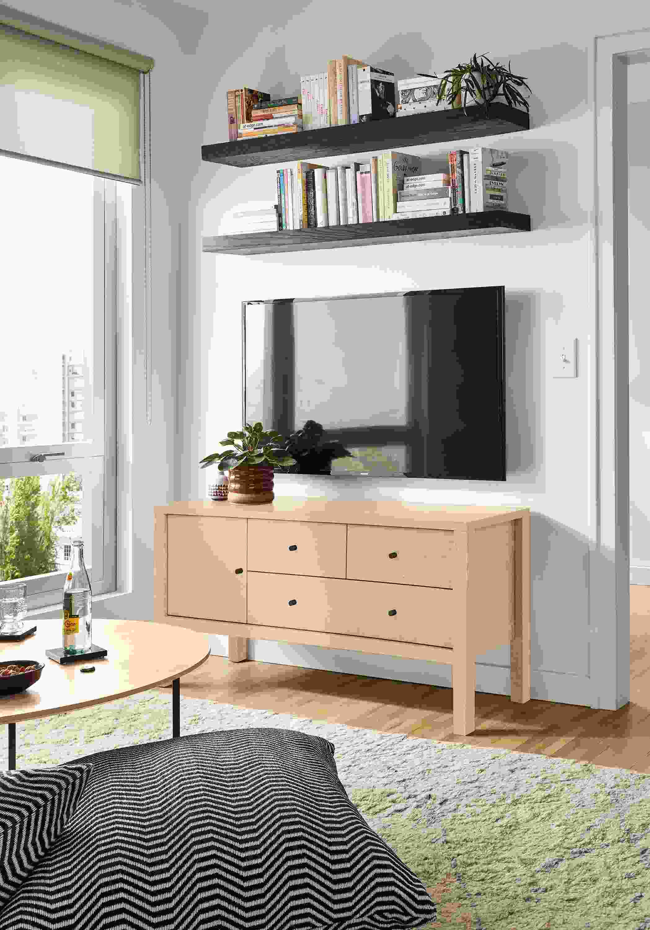 Room setting featuring the Emerson 48-wide media cabinet in salt on red oak and Kalindi rug in cement.