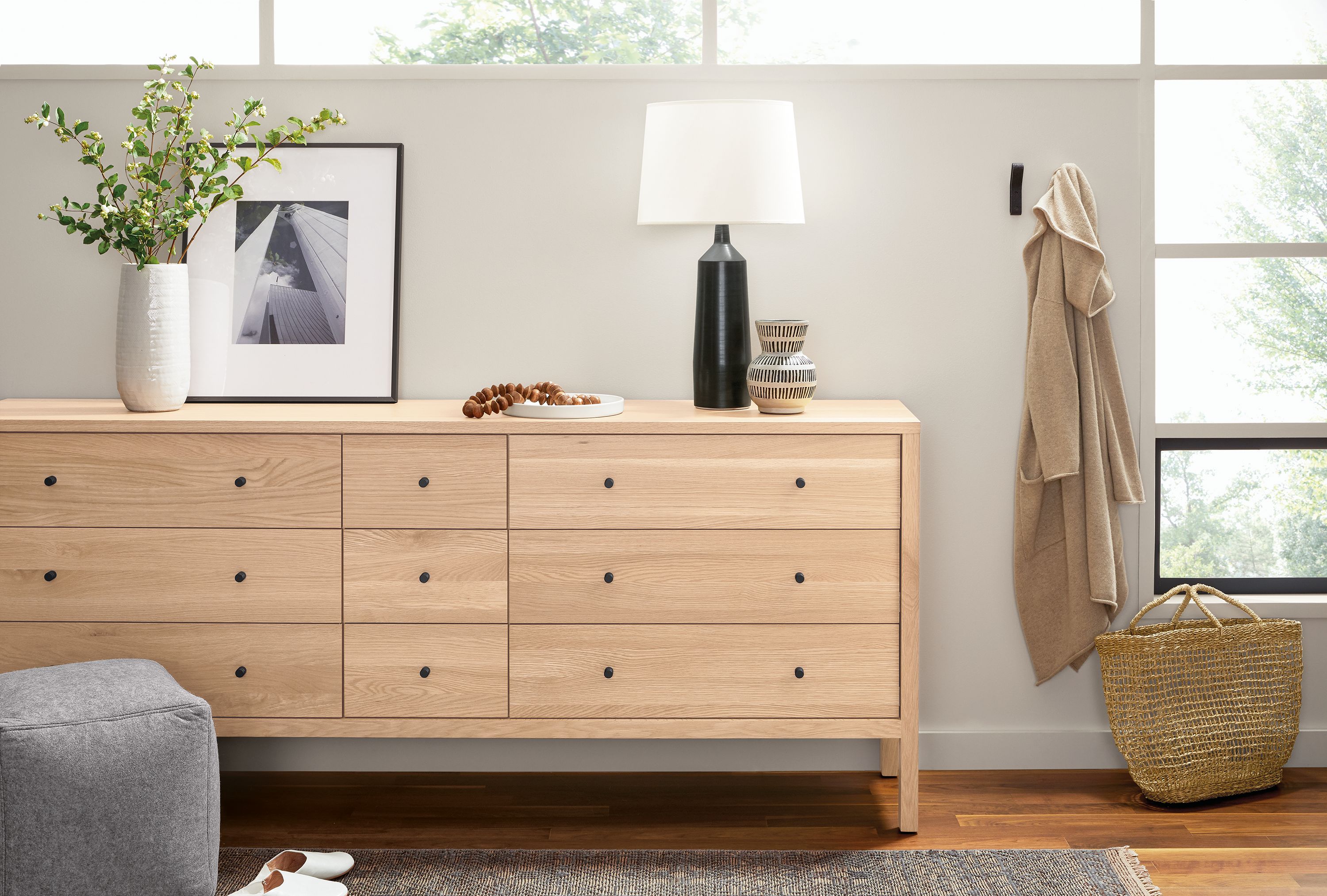 Bedroom with Emerson 84-wide 9-drawer dresser in salt on red oak and Monarch table lamp in coal.