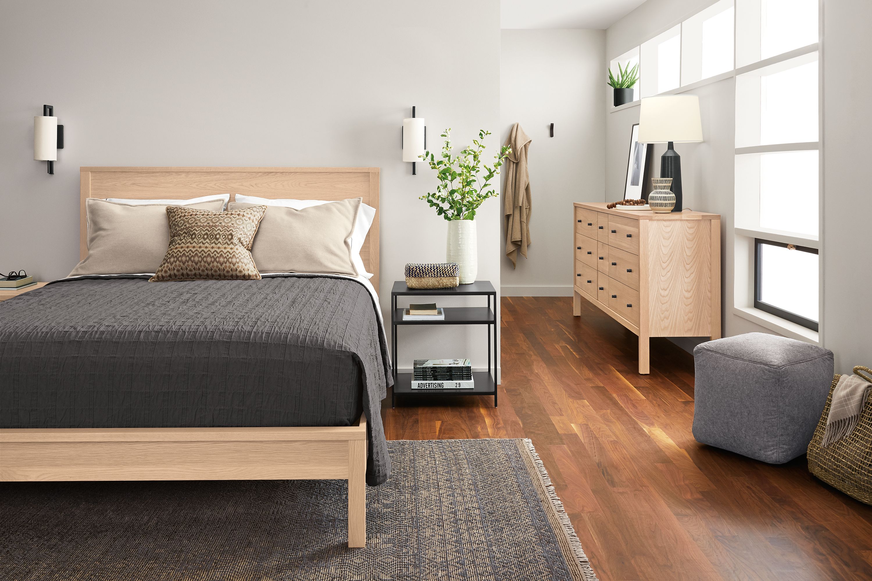 Bedroom with Emerson queen bed, nightstand and dresser in salt on red oak and slim end table in natural steel.