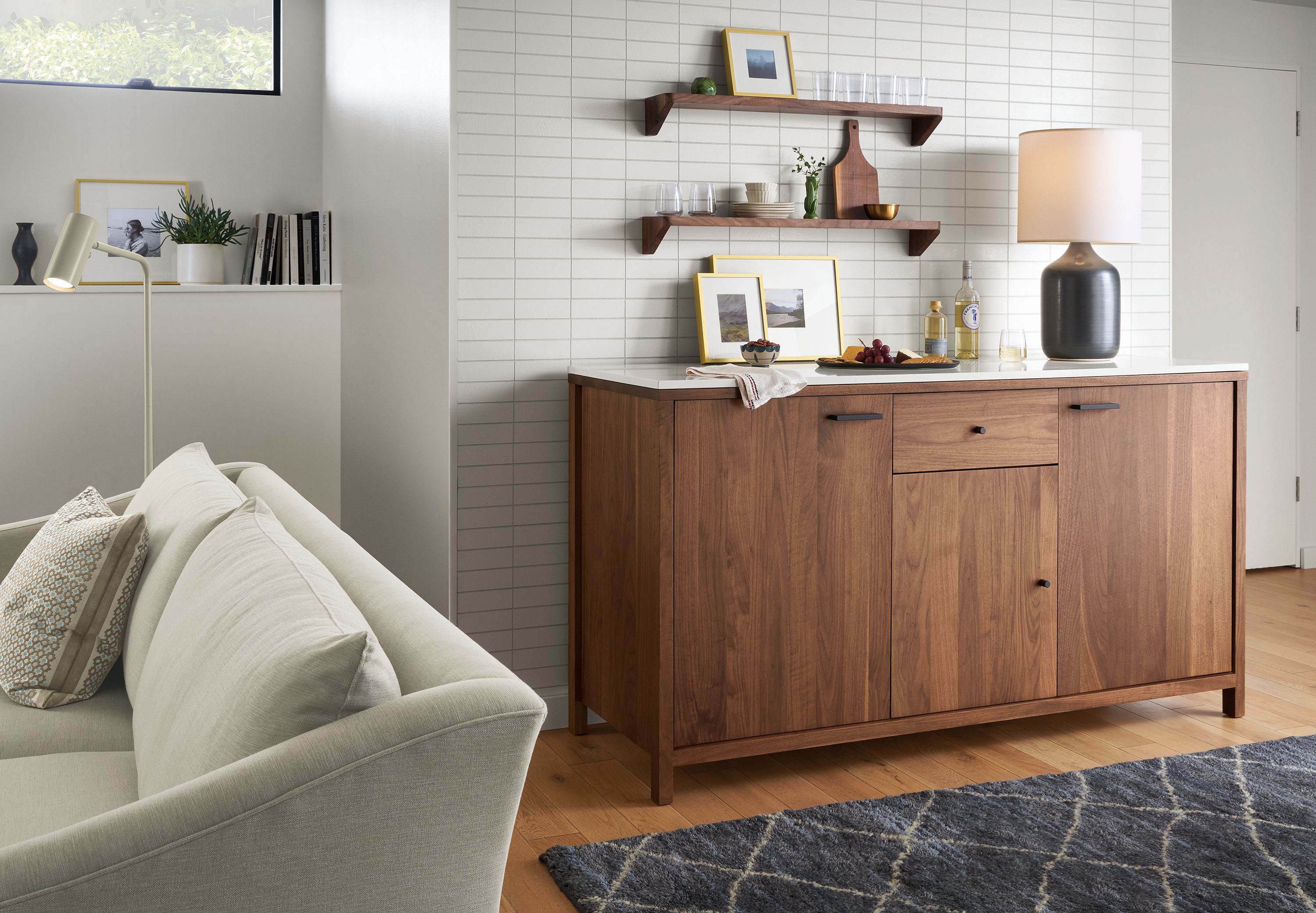 Living room with Emerson 72 wide double fridge cabinet in walnut, Maeve 93 wide two cushion sofa in Yana Natural and Kalindi 6 x 9 rug in Smoke.