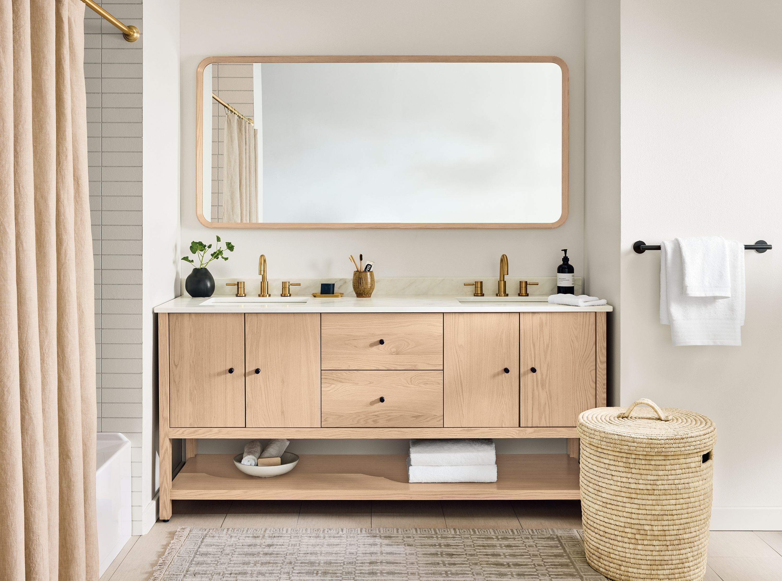 Bathroom with Emerson 72-wide double sink vanity in salt on red oak with marbled warm white quartz top.