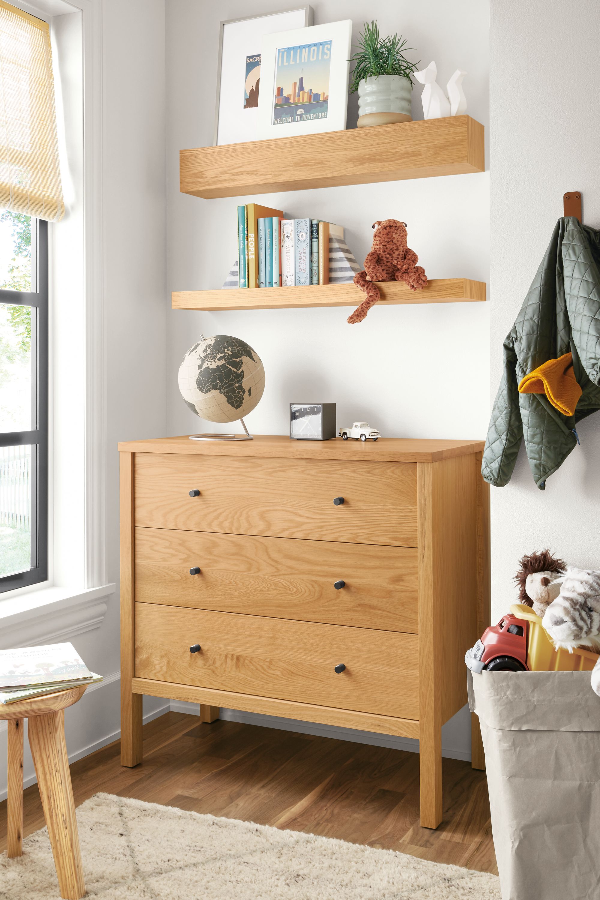 Detail of Emerson dresser in white oak in kids bedroom below Float shelves.