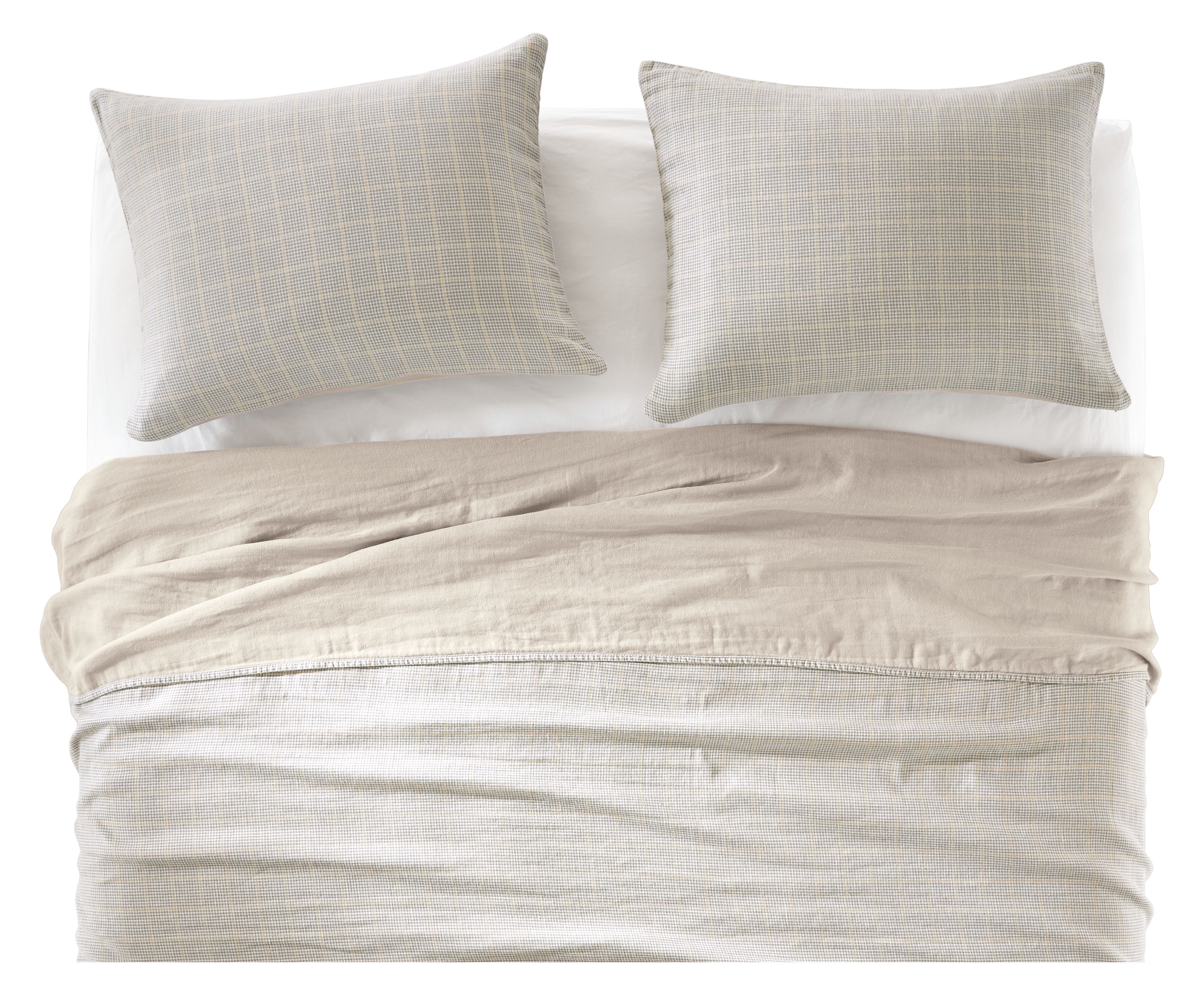 detail of emma coverlet set and signature percale bedding on bed.