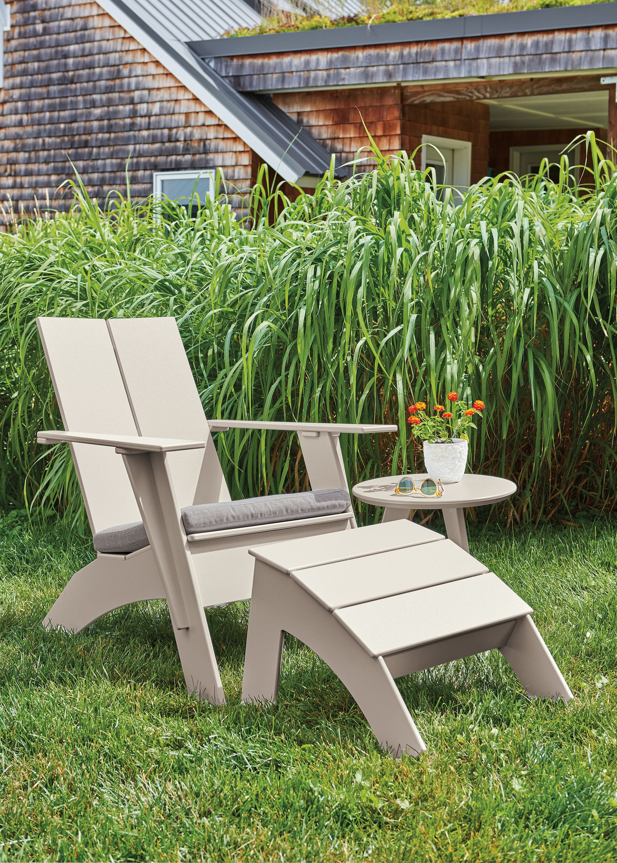 Lounge chair and ottoman with cushion in Pelham smoke fabric and fog frame