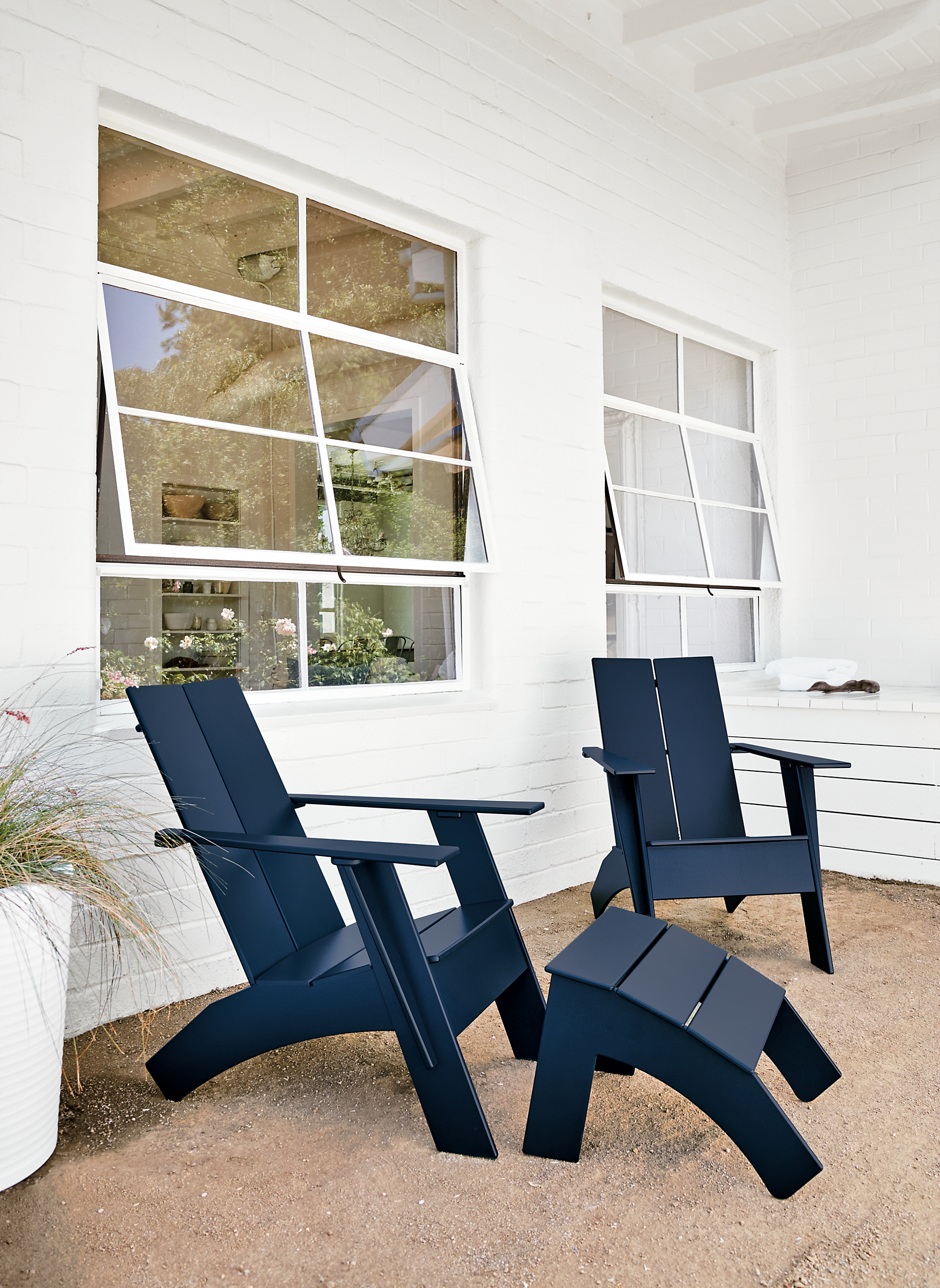 Patio with Emmet tall lounge chair in navy.