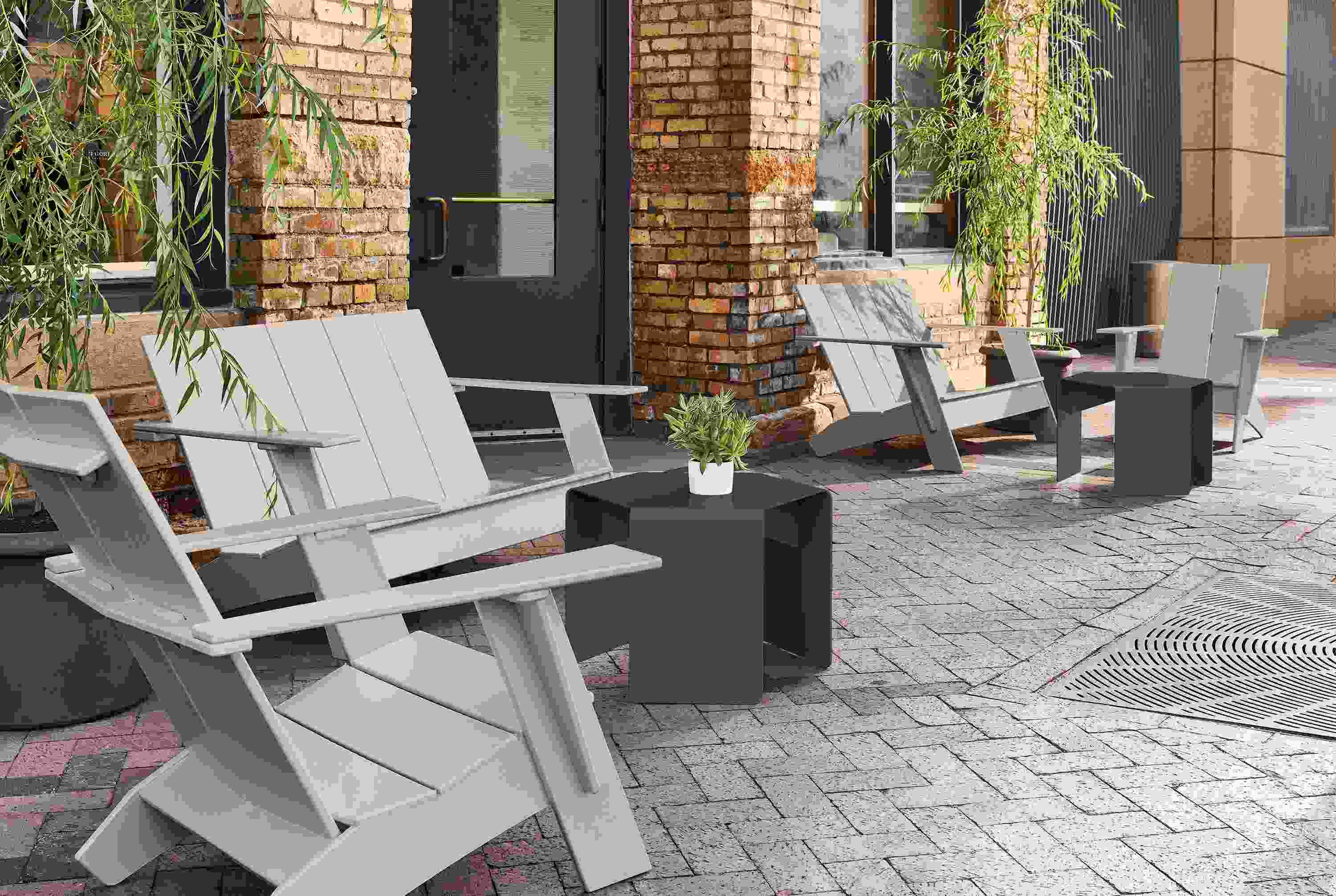 Outdoor space with emmet sofas and chairs in fog, cell side tables in graphite and gilyard planters in grey terracotta.