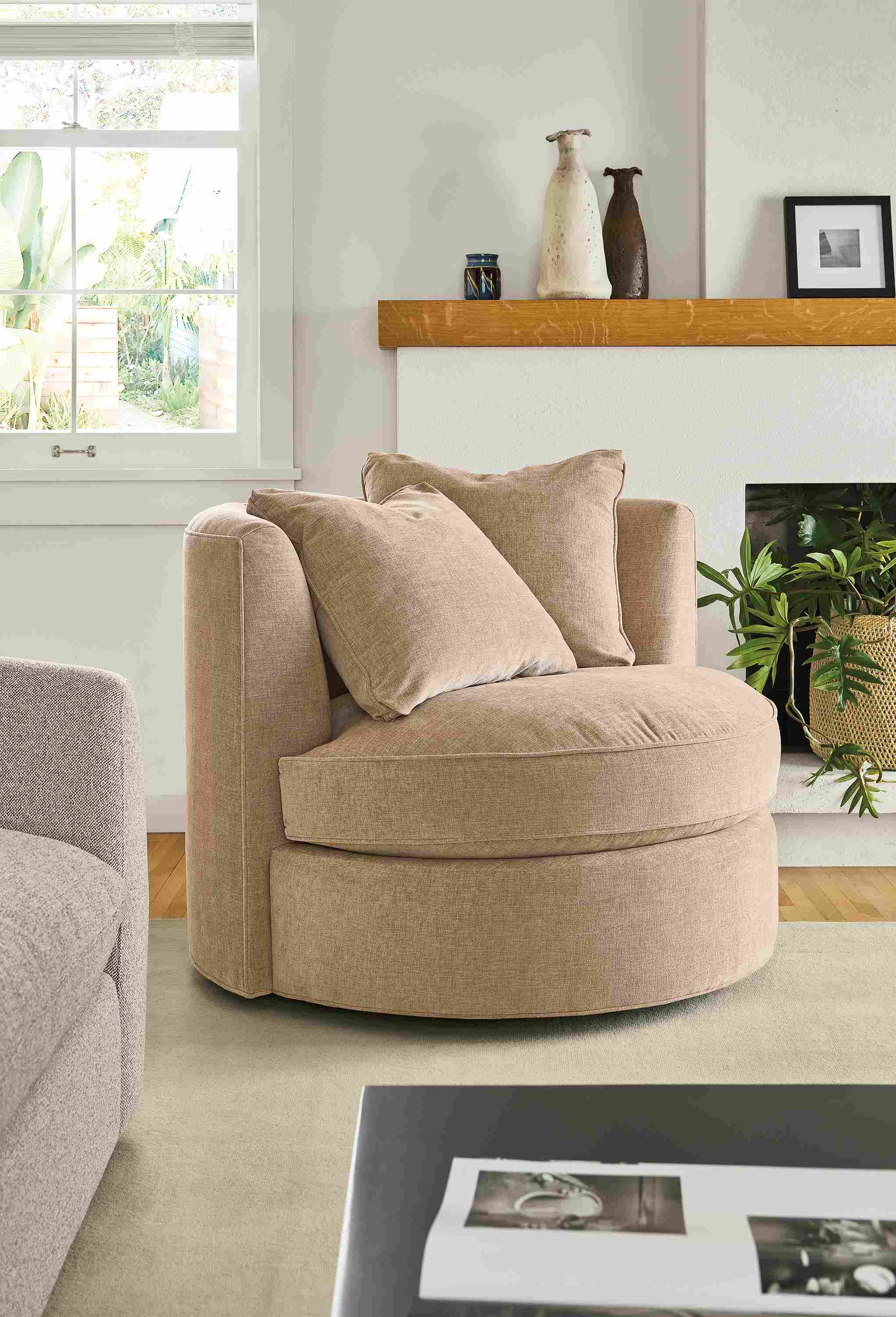 Living room with Eos swivel chair in Mori Camel, Luco rug in silver and Wever sofa in Tatum Bone.