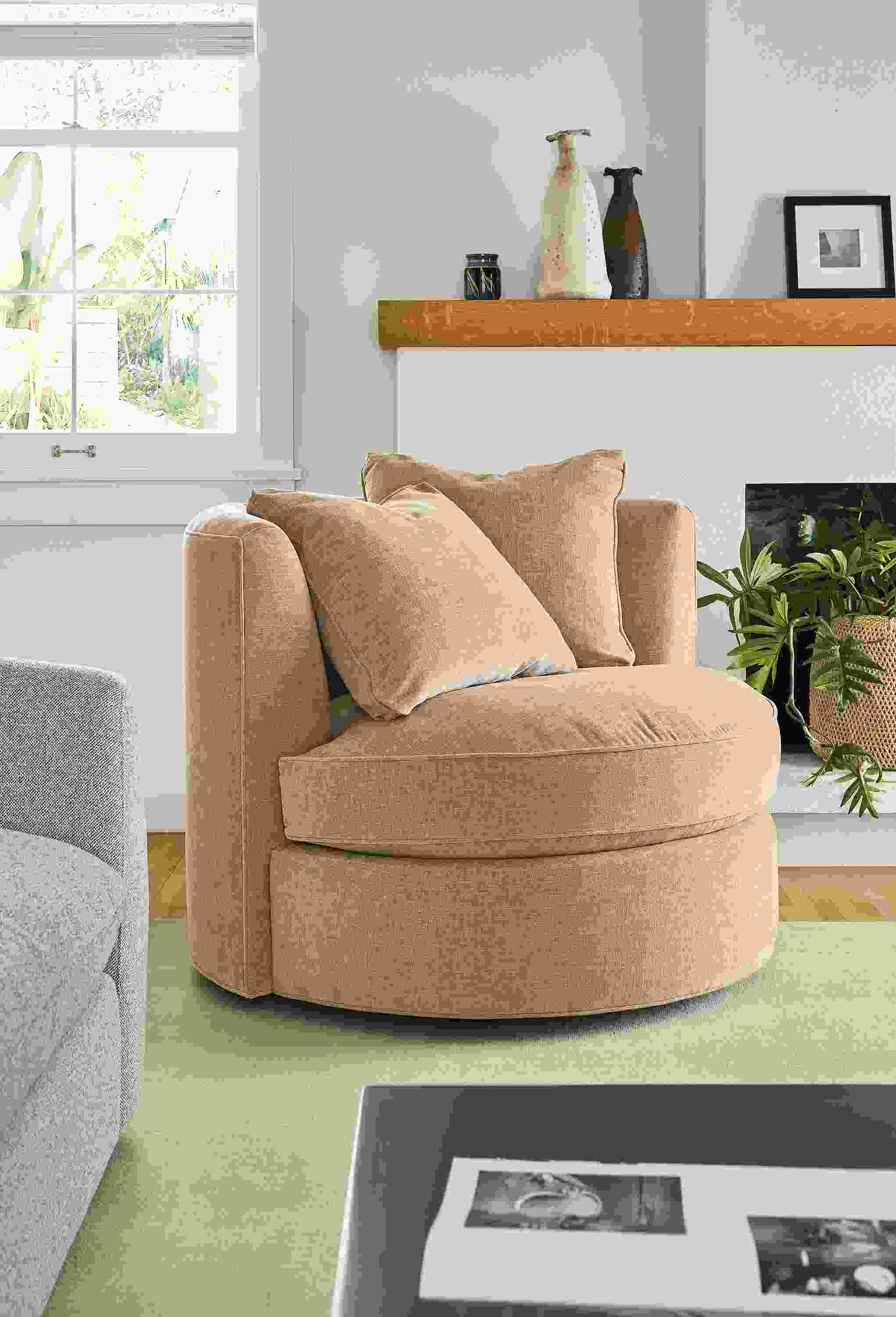 Living room with Eos swivel chair in Mori Camel, Luco rug in silver and Wever sofa in Tatum Bone.