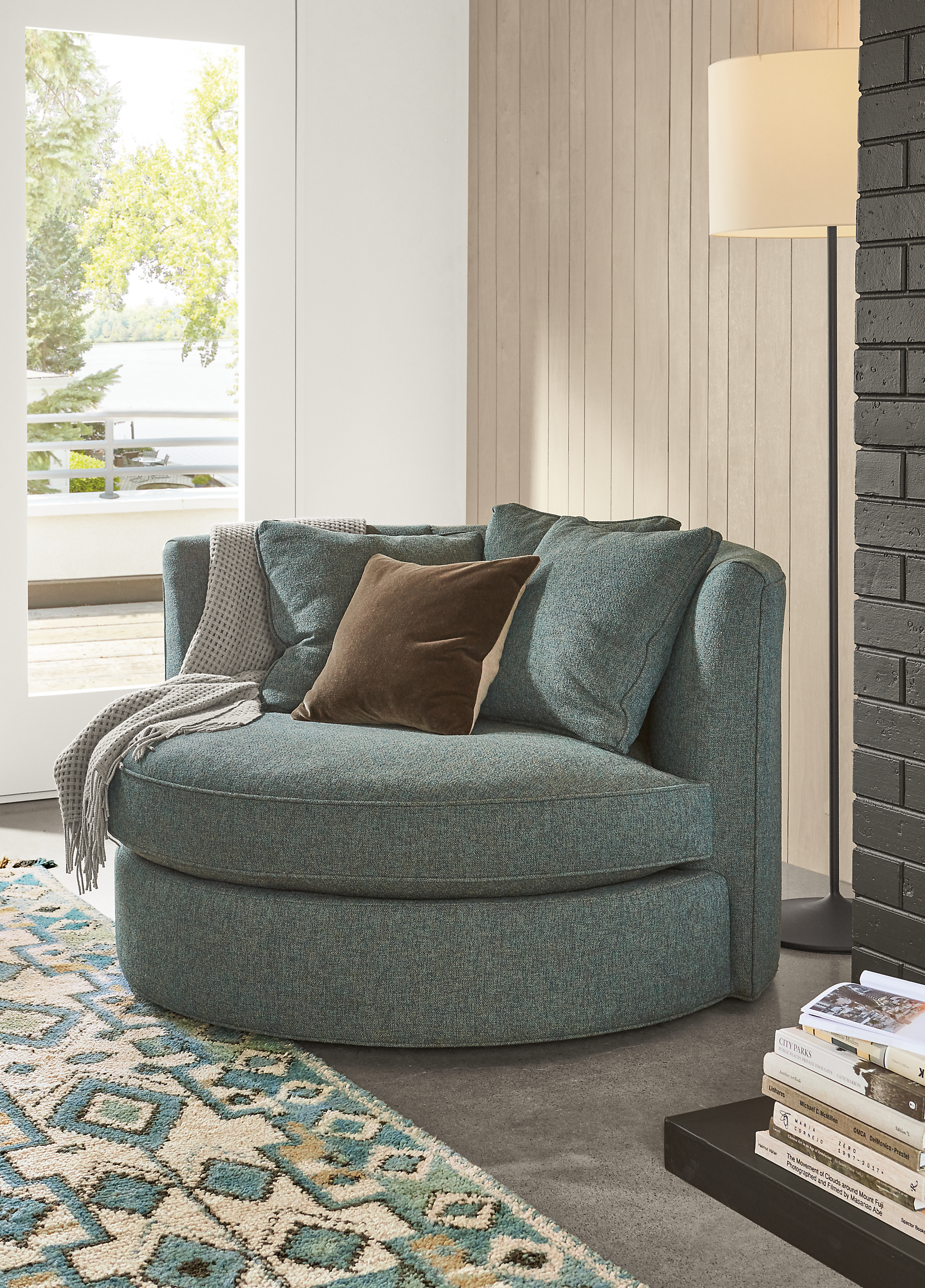 Detail of Eos swivel chair in Tatum Haze fabric in living room.