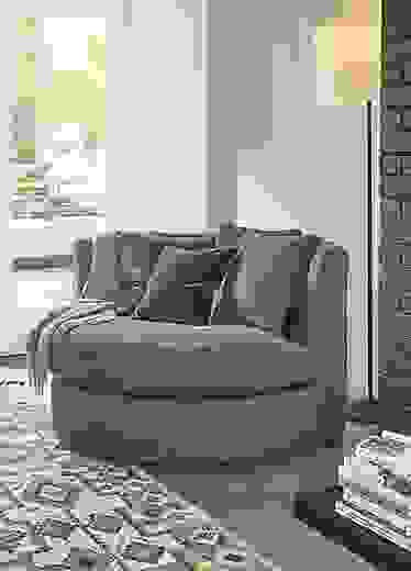 Detail of Eos swivel chair in Tatum Haze fabric in living room.