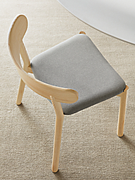 close-up of erwin chair in ash wood with gray fabric seat