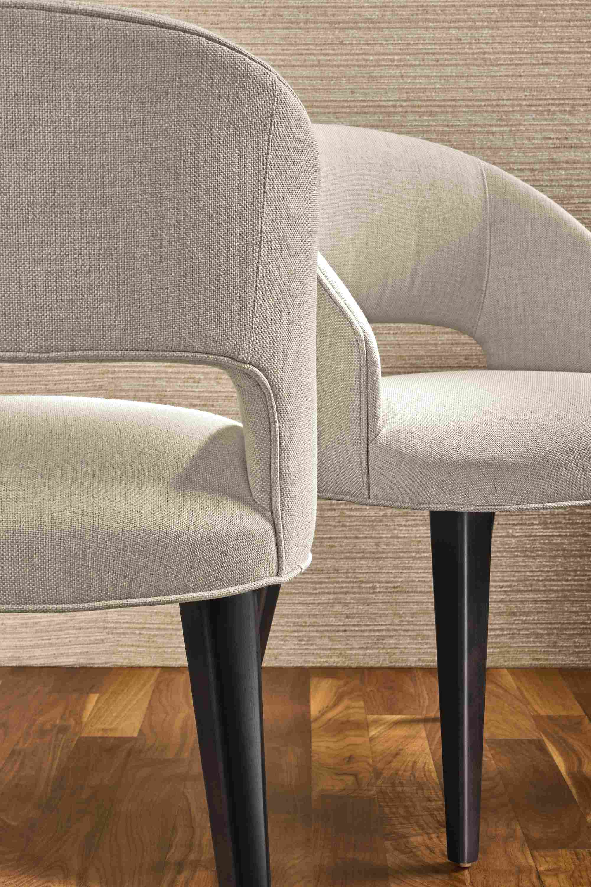 Detail of back and front of 2 Esme chairs in Sumner Linen with charcoal legs.