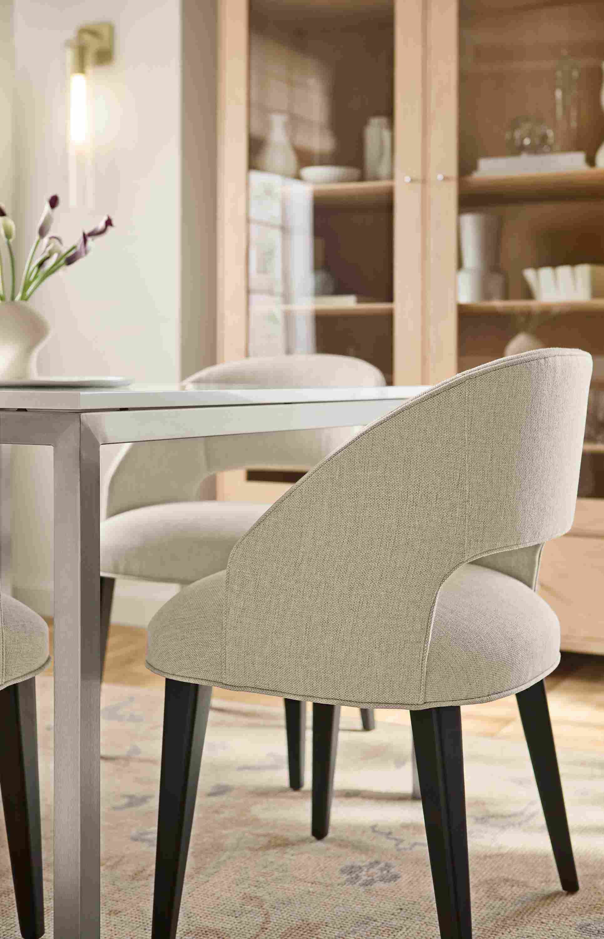 Dining room with detail of Esme chair in Sumner Linen with charcoal legs and Parsons table in stainless steel.