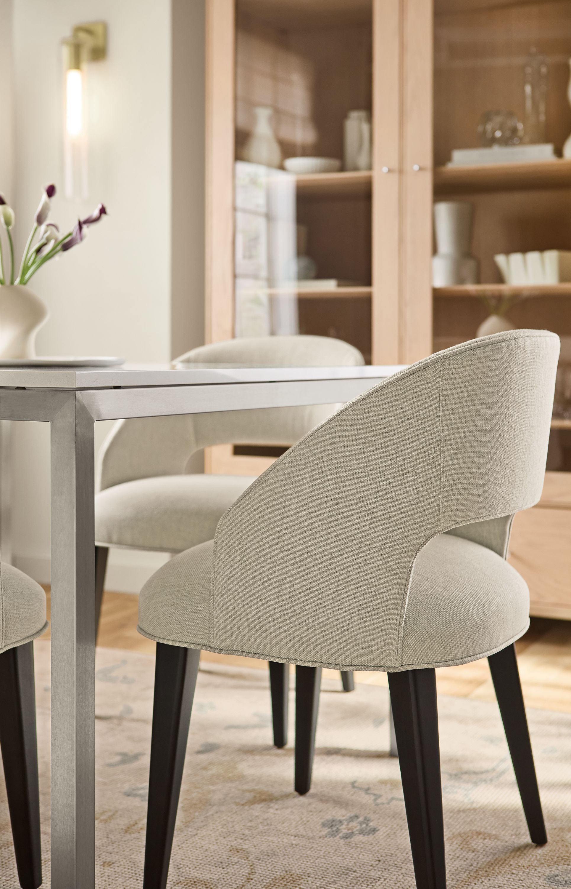 Dining room with detail of Esme chair in Sumner Linen with charcoal legs and Parsons table in stainless steel.