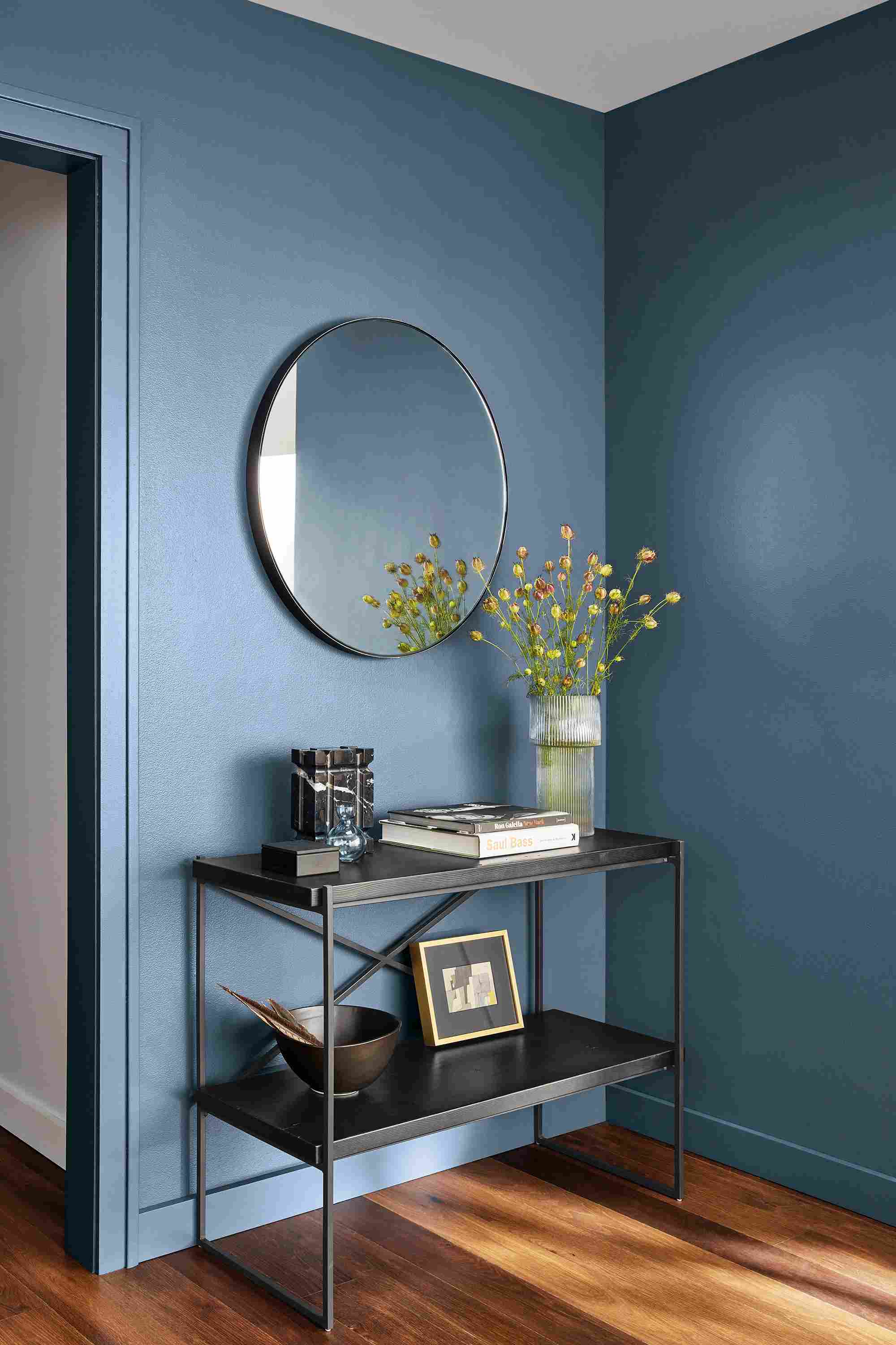 etting reclaimed wood console bookcase in room with infinity mirror.