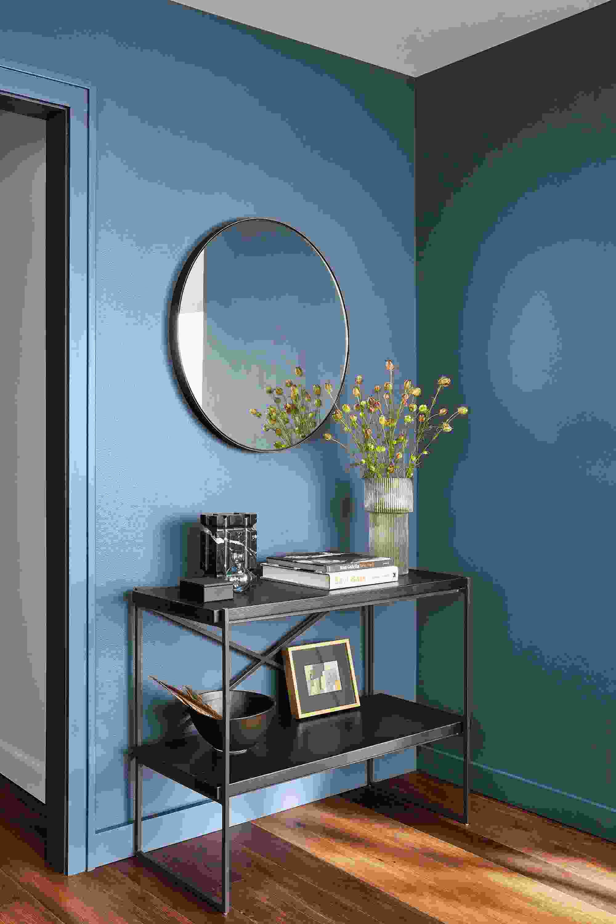 etting reclaimed wood console bookcase in room with infinity mirror.