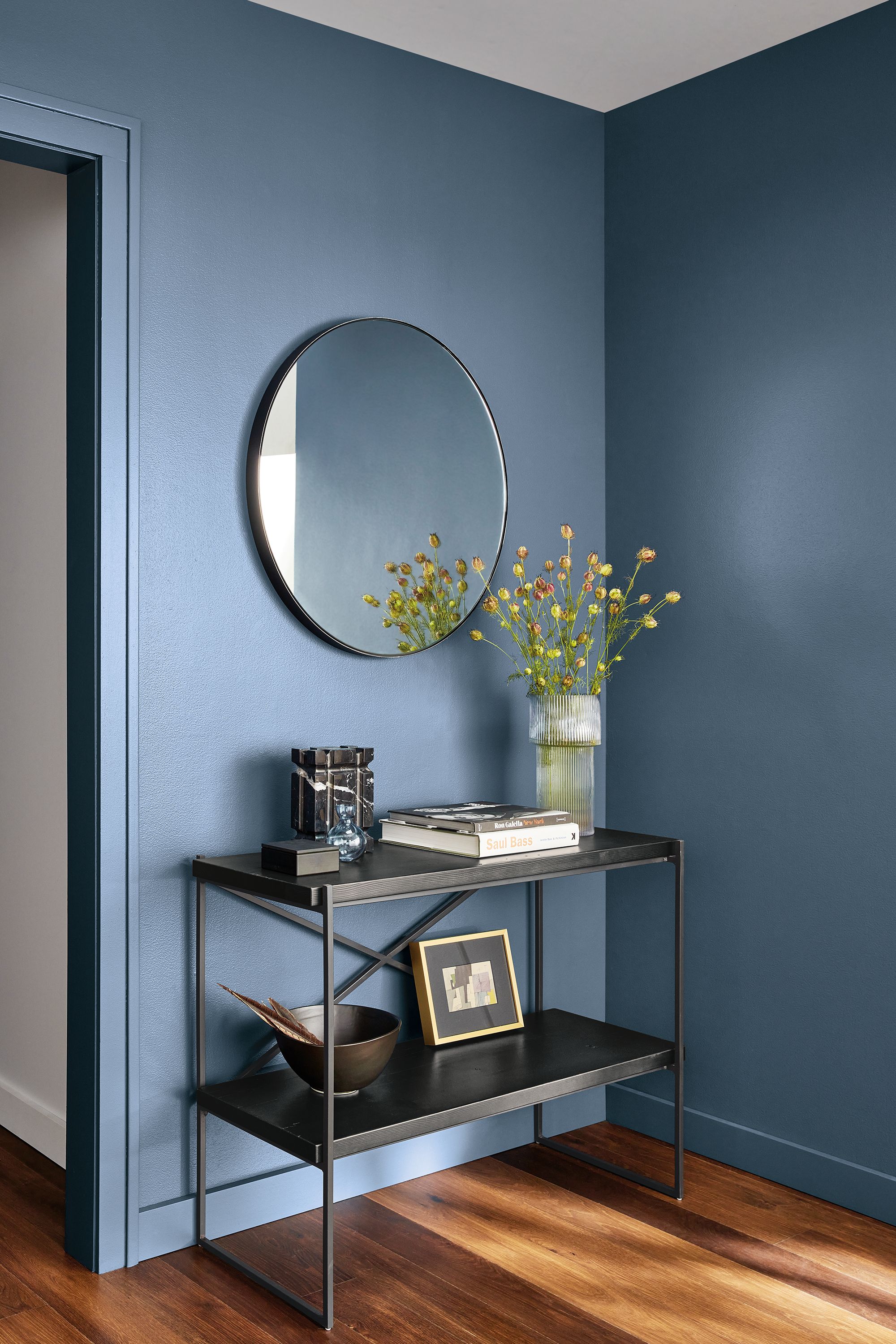 etting reclaimed wood console bookcase in room with infinity mirror.