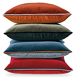 stack of throw pillows in Sienna,Fir, Blue and Red.