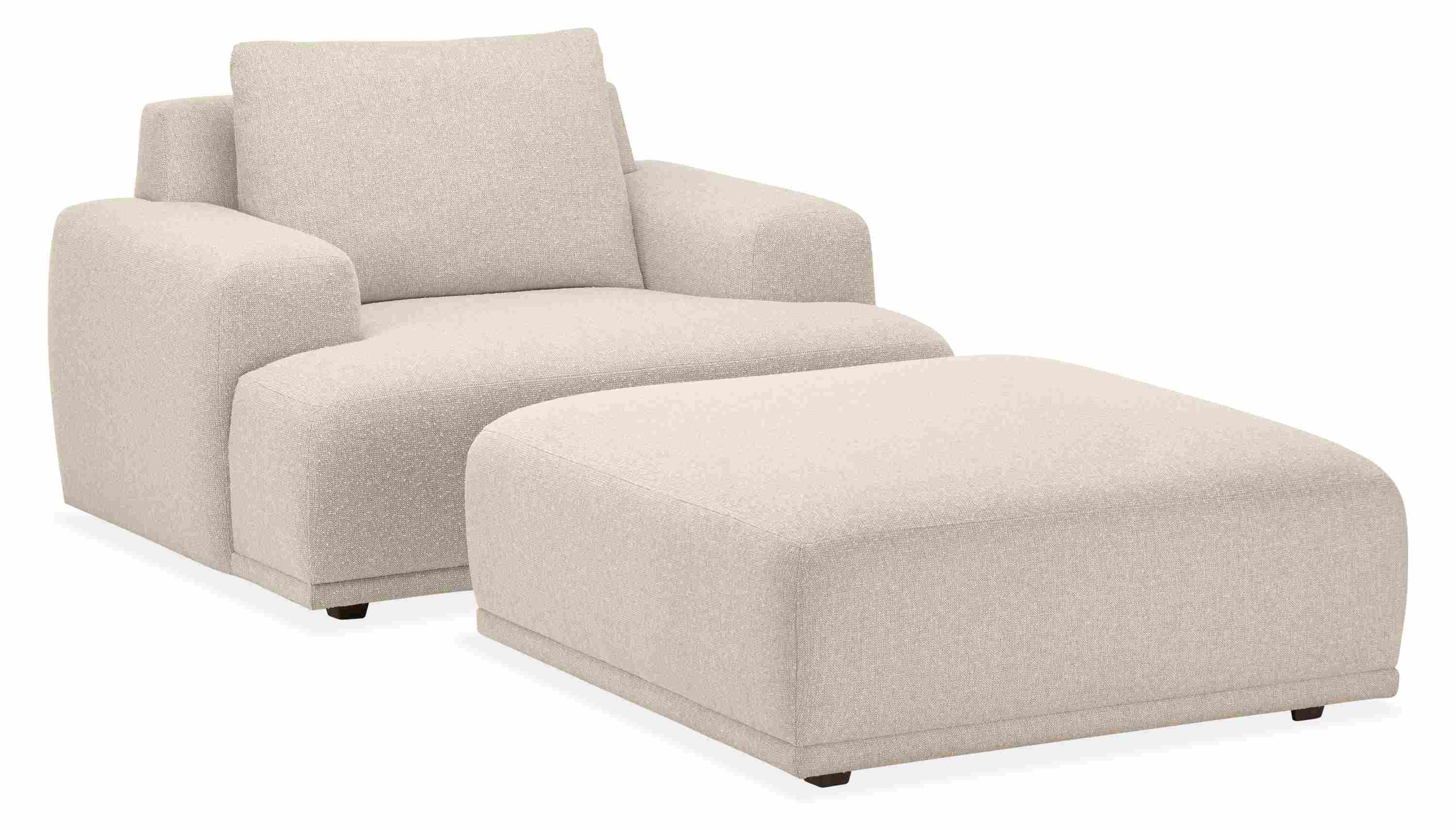 Angled view of Fia Chair and Ottoman in Conley Natural Fabric.