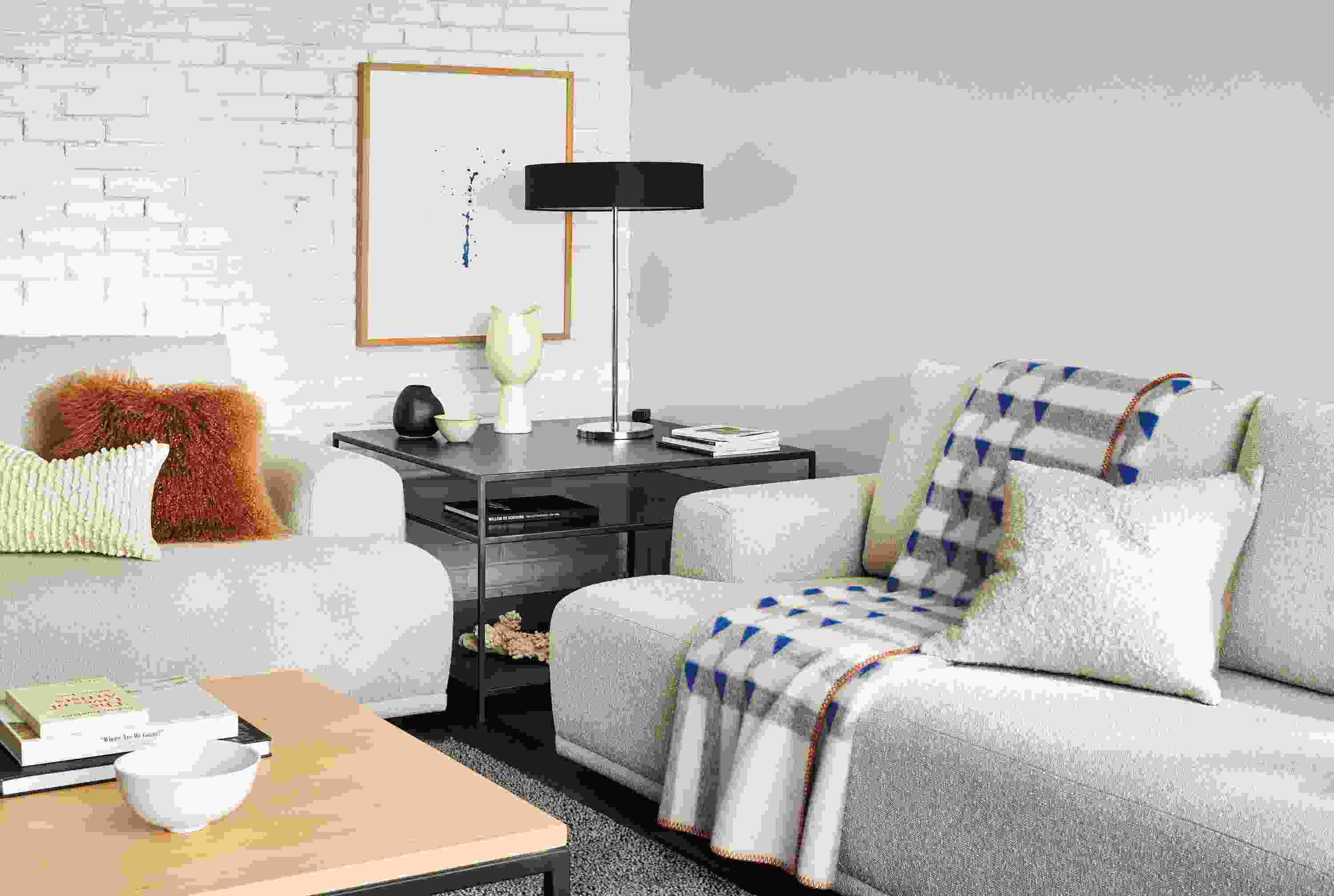 room setting with two Fia sofas, kvam throw blanket, cohen table lamp.