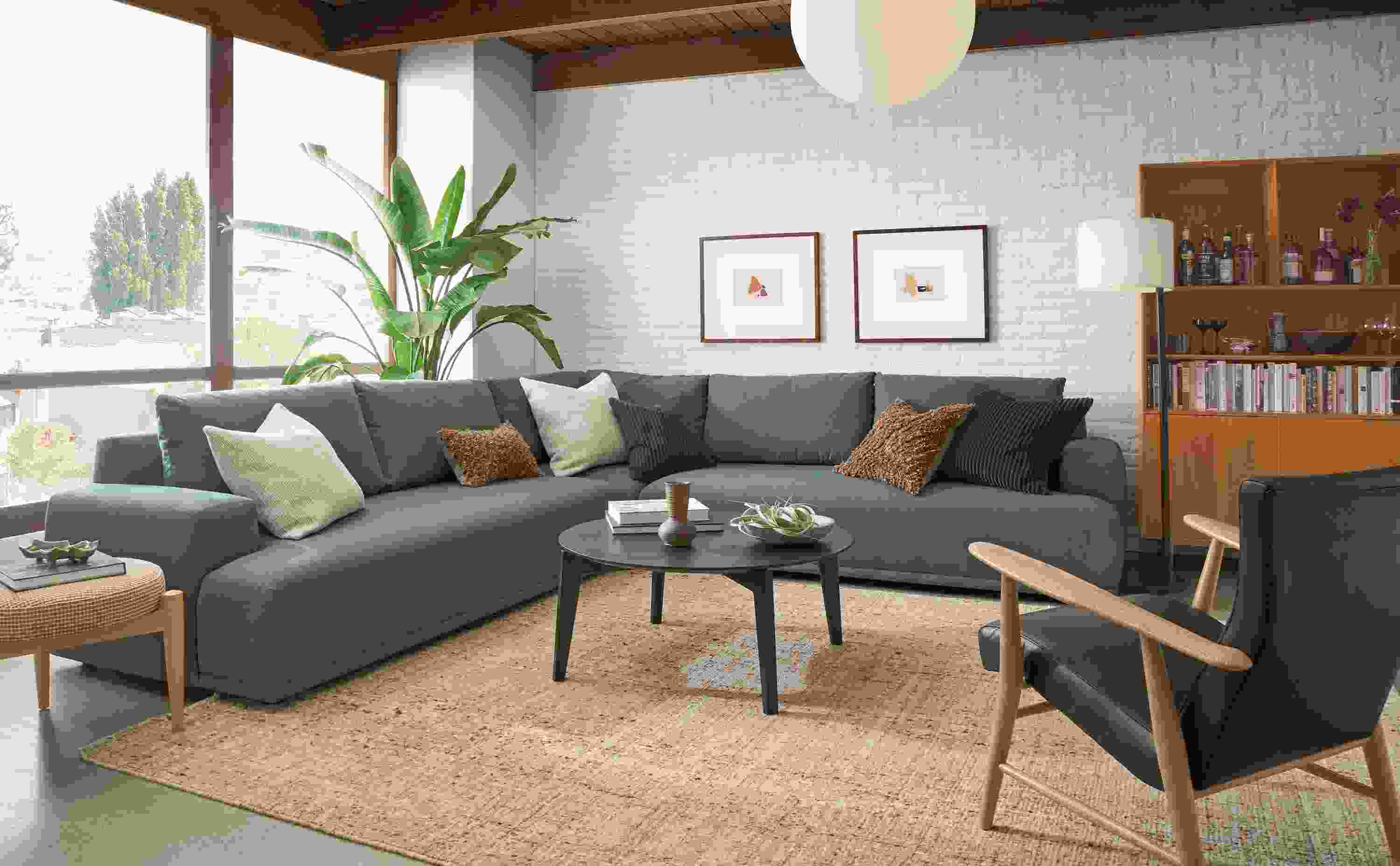 Living room with Fia 121 by 121 sectional 3-piece sofa in Myers Pine and Jonas chair in Palermo Charcoal leather.