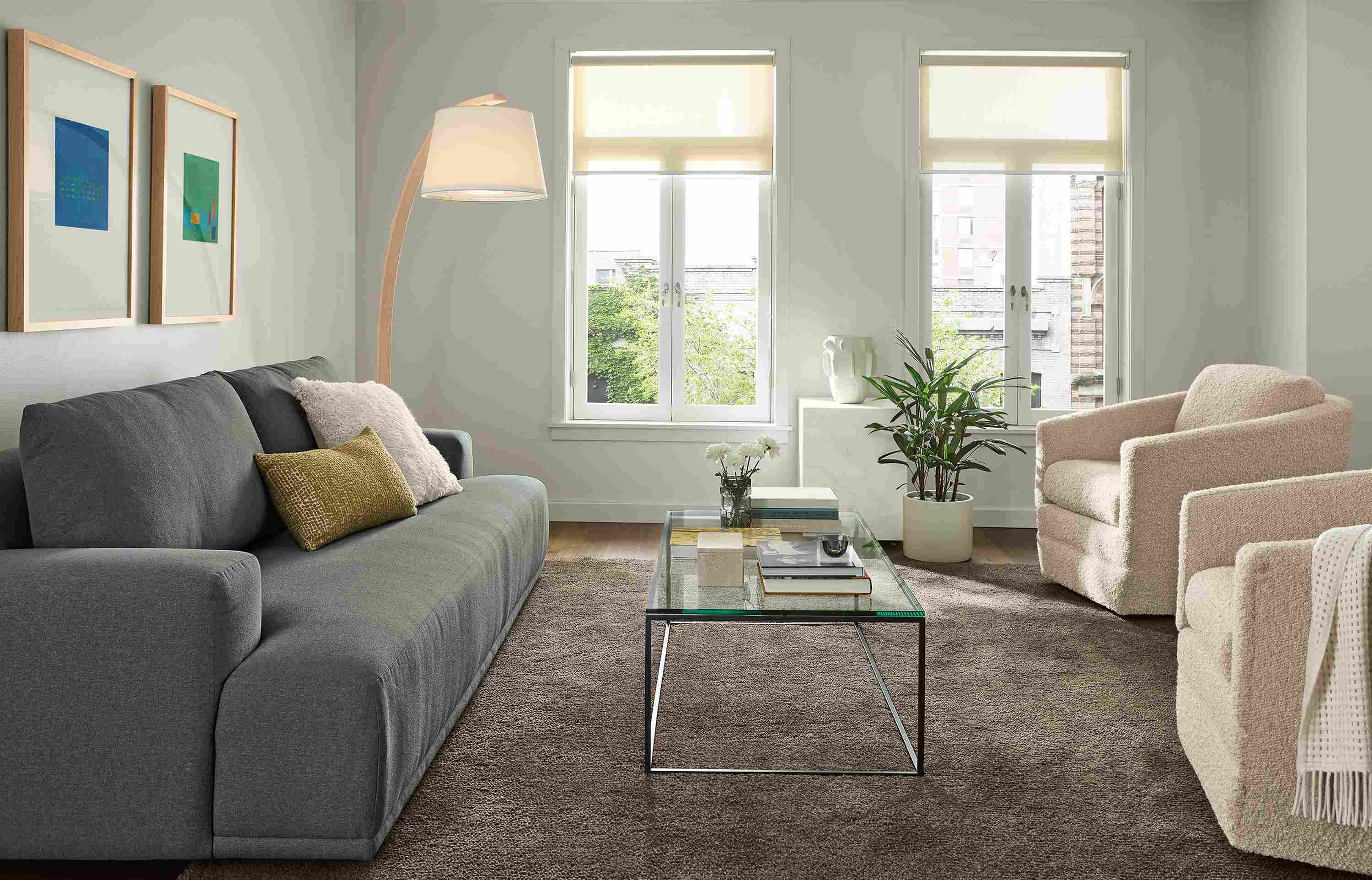 Living room with Fia 96-wide sofa in Myers Pine, 2 Ford swivel chairs in Dornick Ivory and Arden 8 by 10 rug in earth.